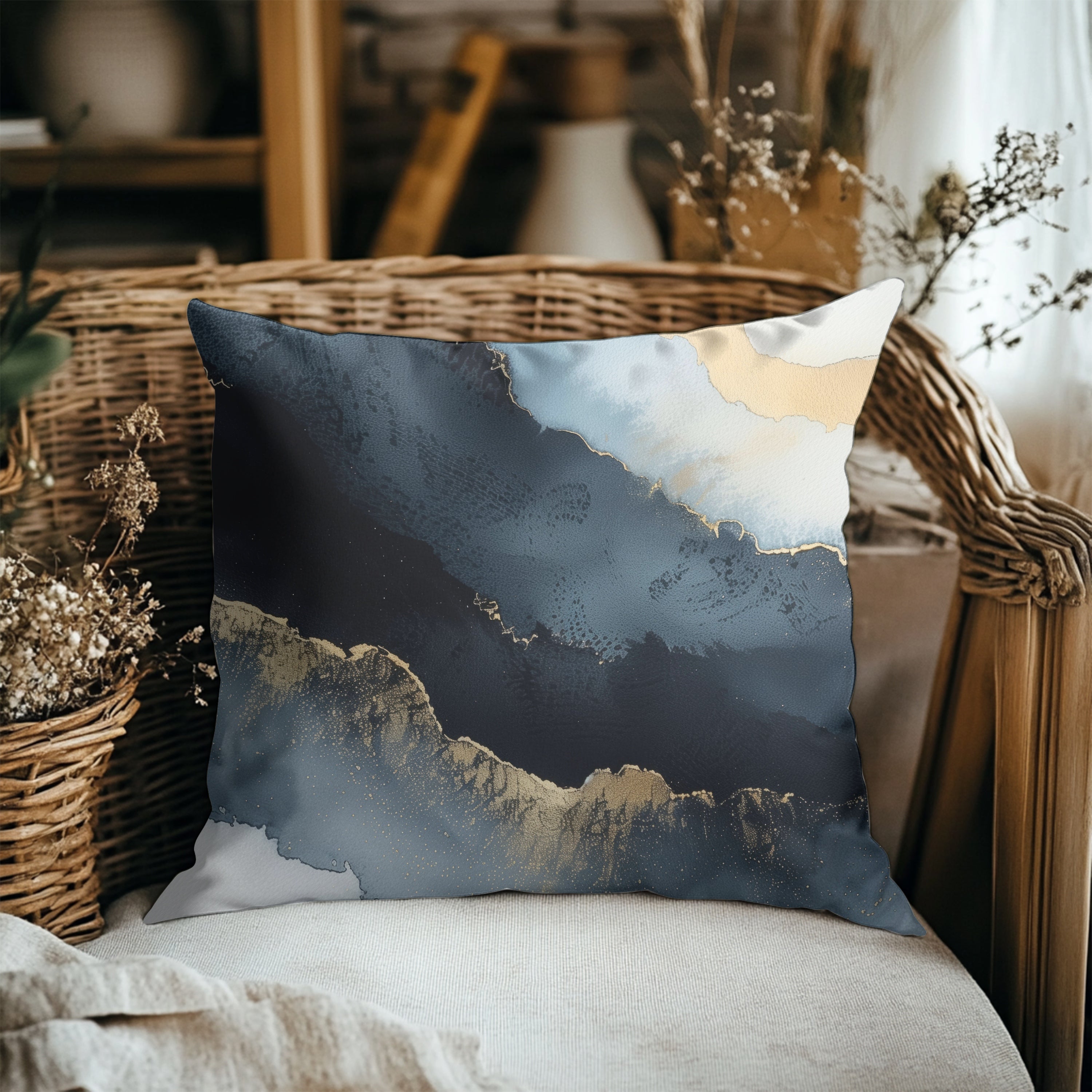 a decorative pillow with a blue and white abstract design, placed on a wicker chair.