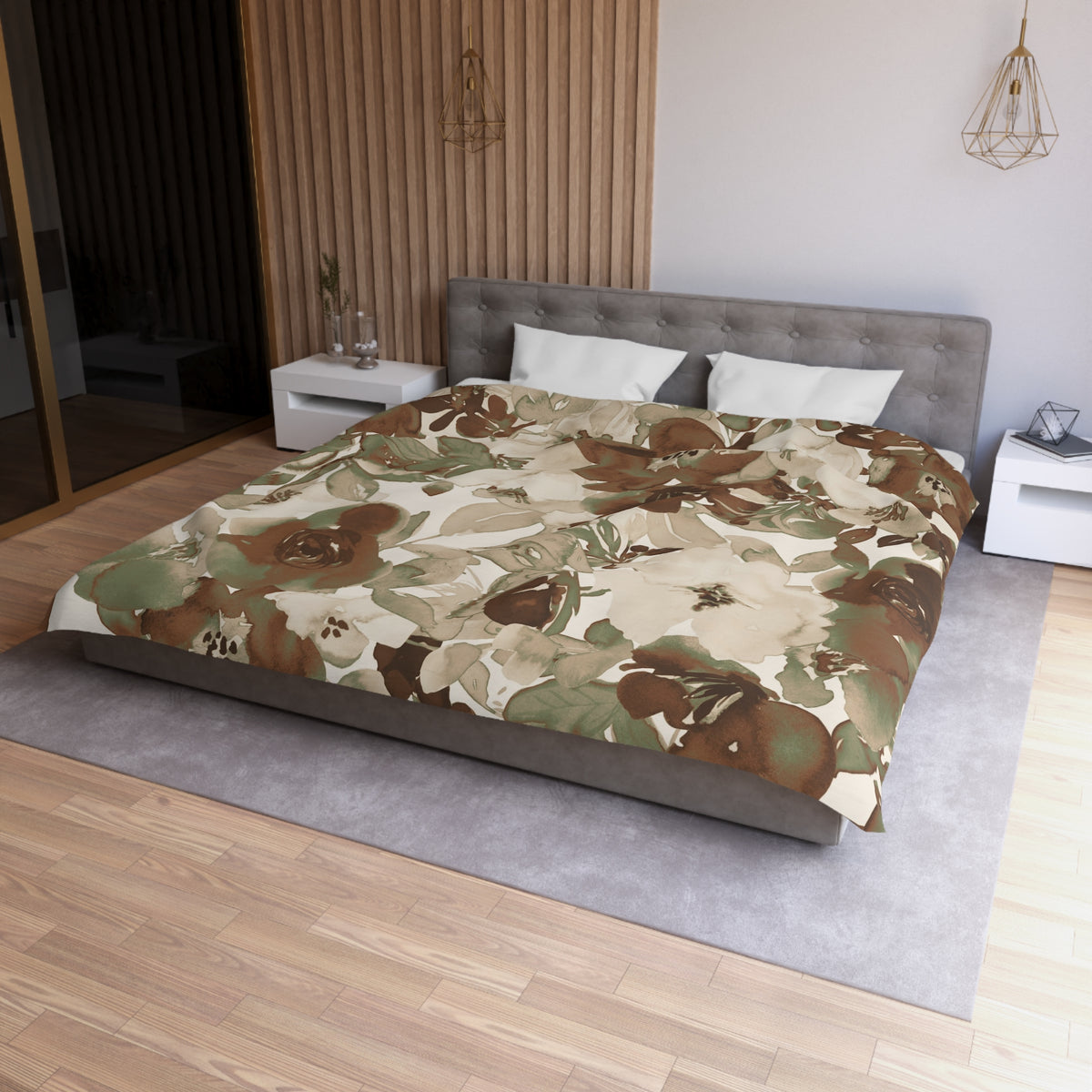 a modern bedroom with a large bed covered in a floral print comforter. The bed is positioned against a wall with a wooden panel. The room has a minimalist design, with a gray headboard and white nightstands. There is a pendant light hanging above the bed, and a vase on one of the nightstands. The overall color scheme of the room is neutral, with the floral print adding a touch of nature and warmth to the space.