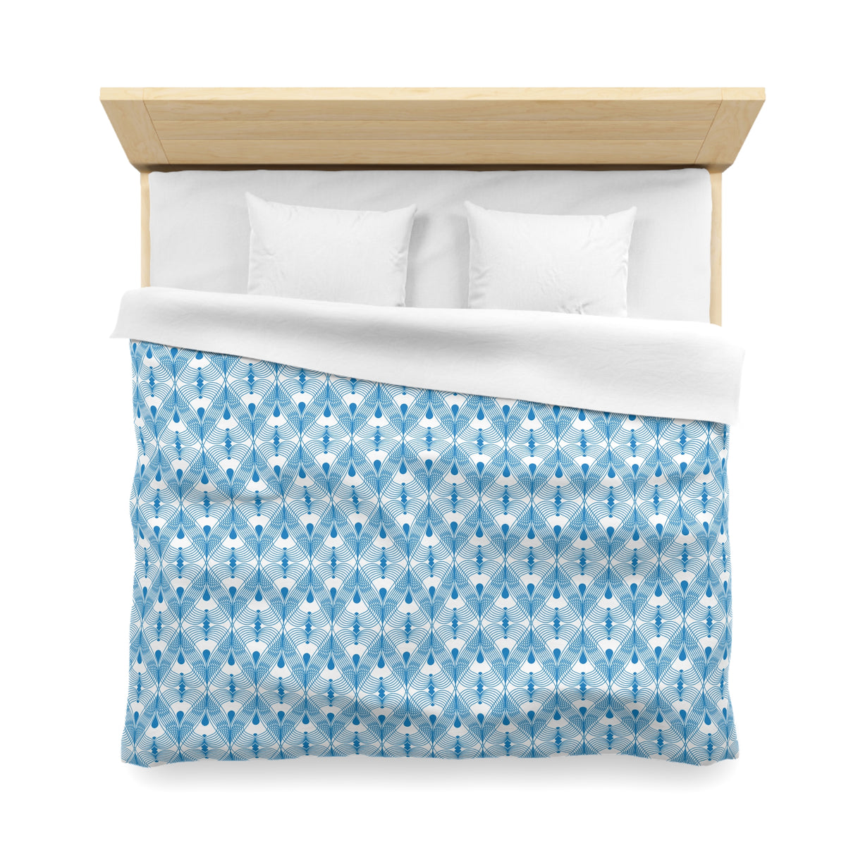 A neatly made bed with a blue and white patterned comforter and two white pillows.