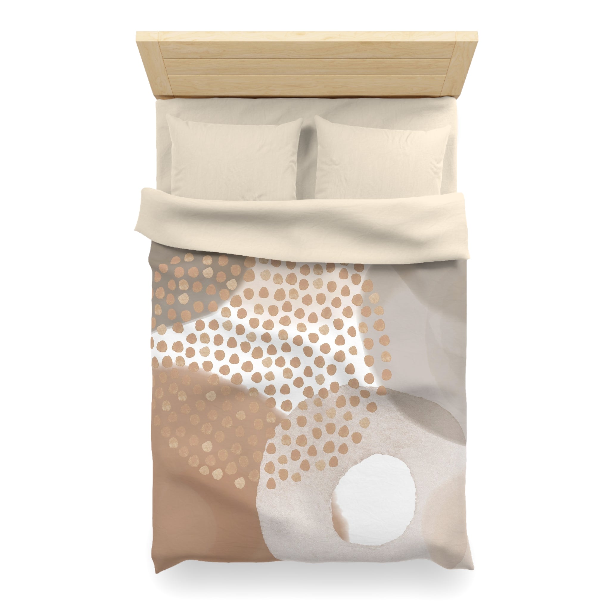 a neatly made bed with a beige comforter and pillows. The comforter has a pattern of brown and white polka dots, creating a visually appealing design.