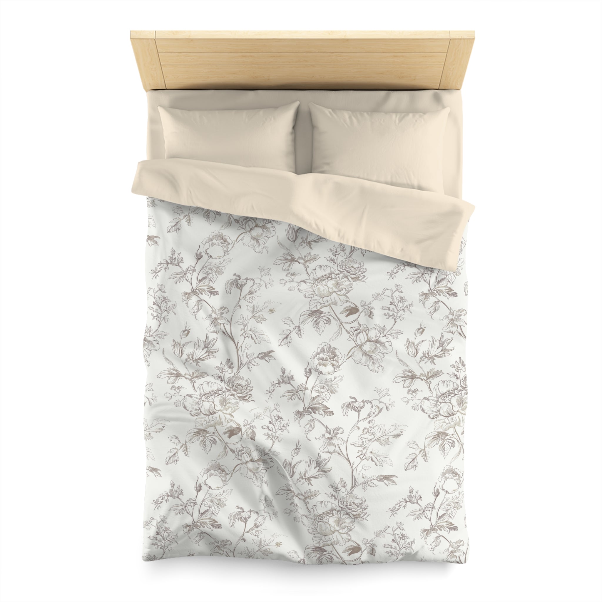 a neatly made bed with a floral print bedspread and matching pillows.