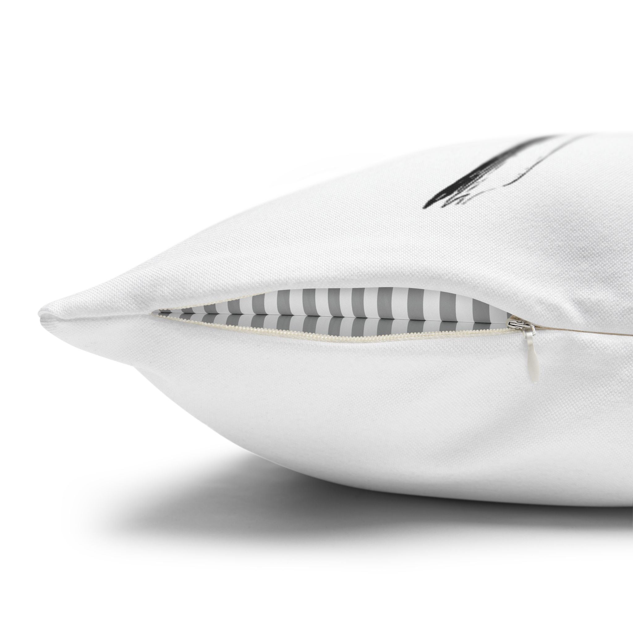 a close-up view of a white pillow with a black stripe on it.