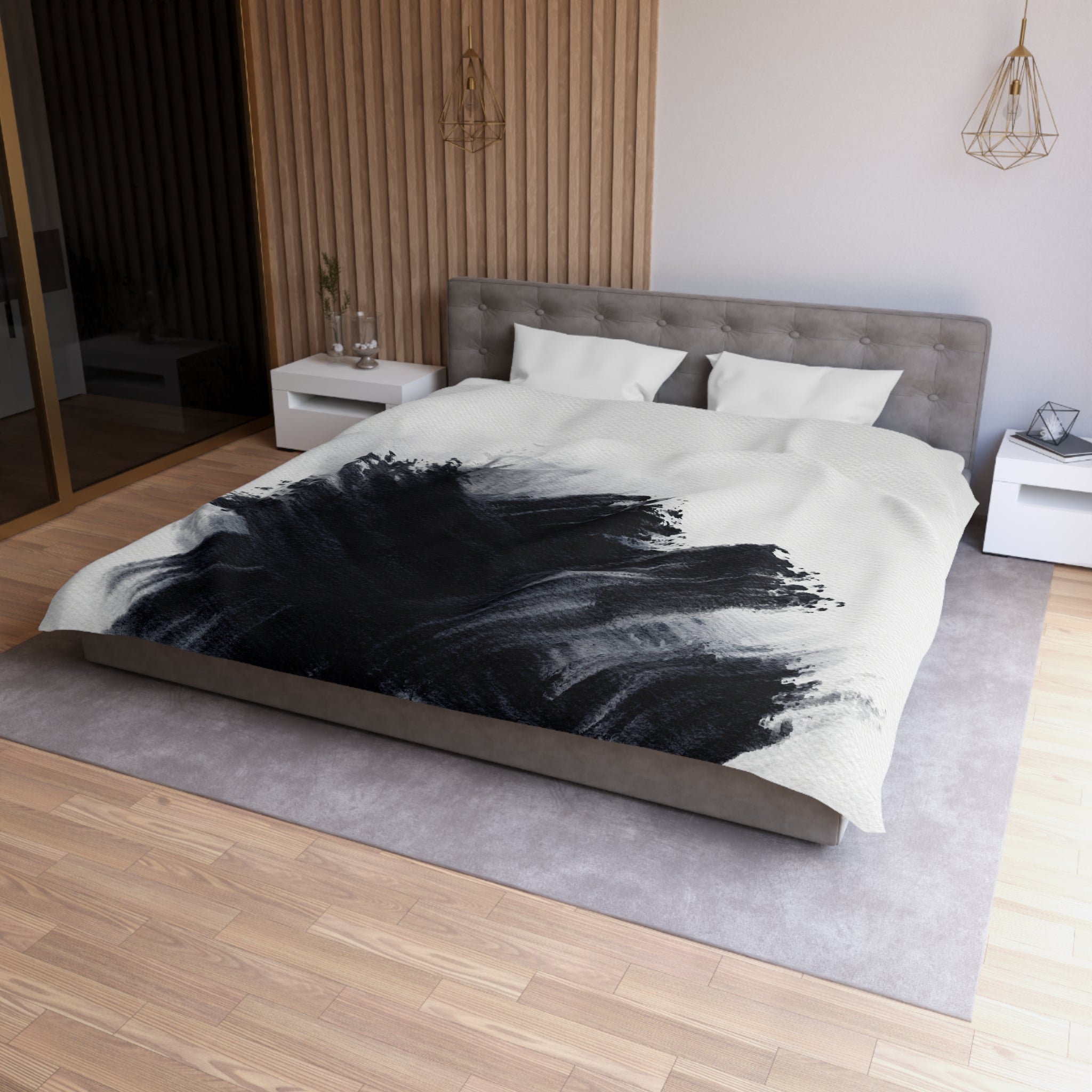 a modern bedroom with a large bed, a gray headboard, and a black and white abstract design on the bedspread.