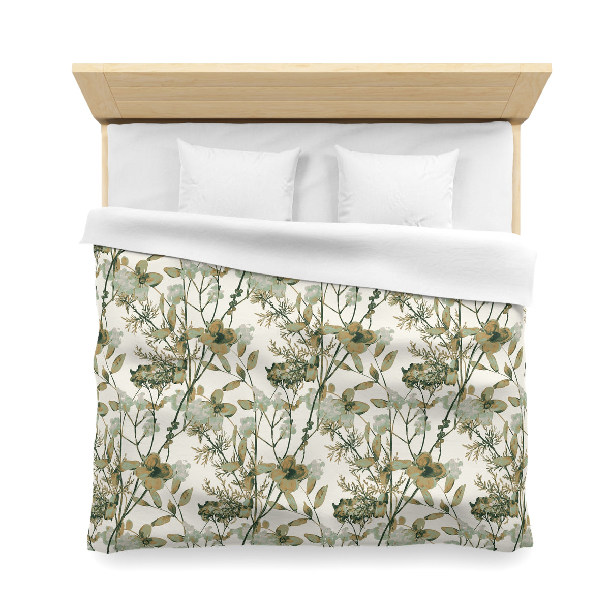 a neatly made bed with a floral print comforter and two white pillows.