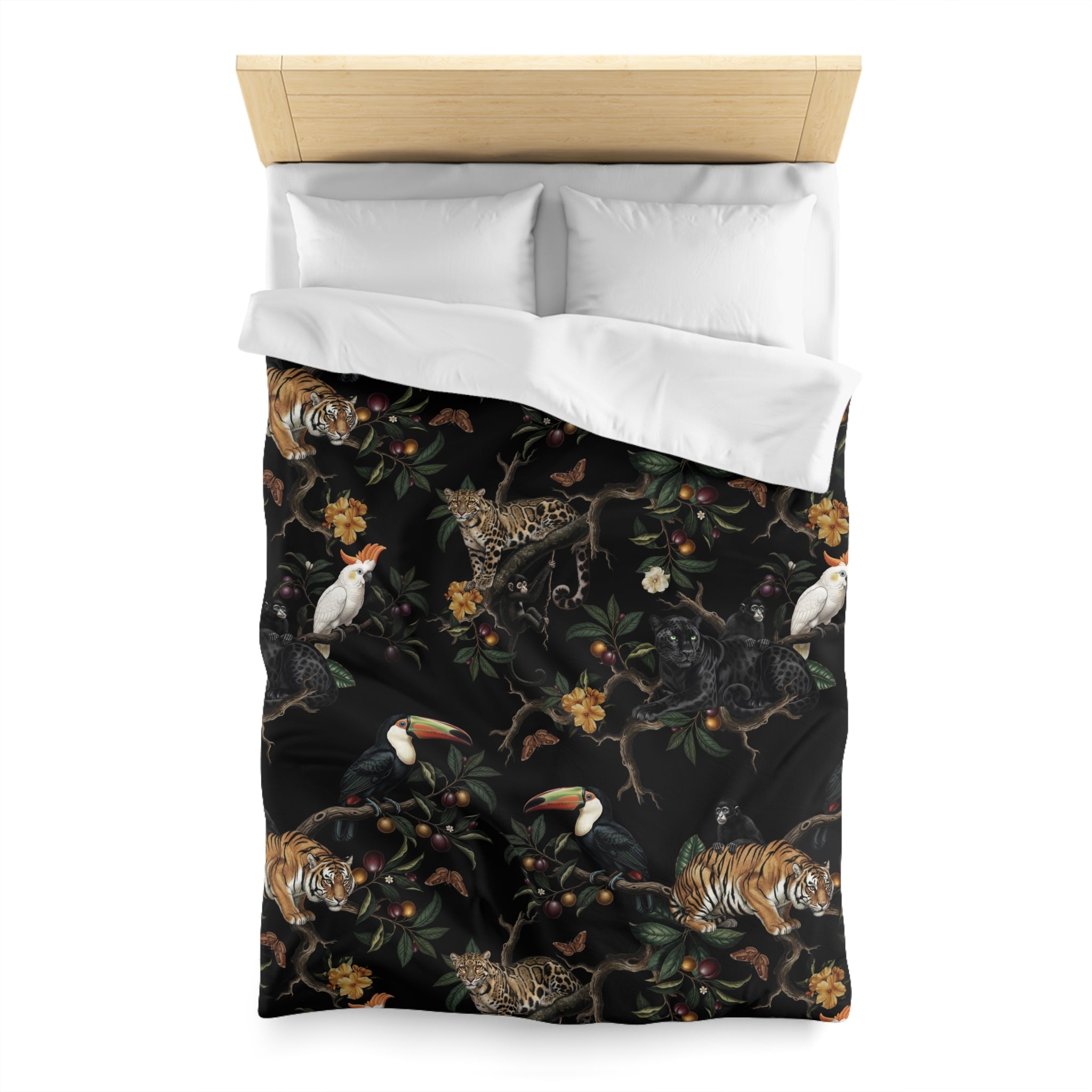 a bed with a black and white patterned comforter that includes various animals such as a tiger, parrot, and bird.