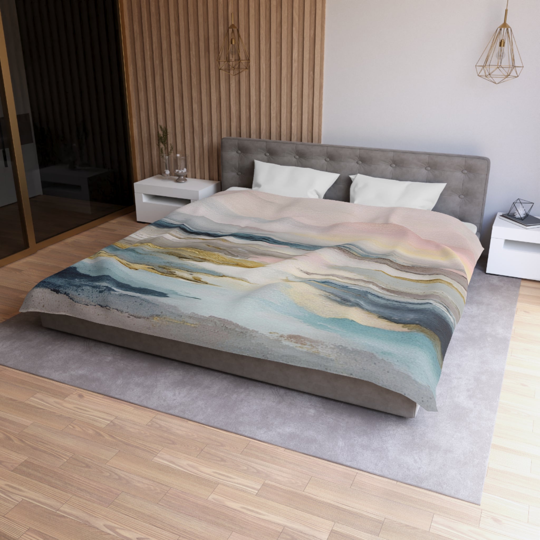 a modern bedroom with a large bed, a gray headboard, and a colorful abstract patterned comforter. The room has a wooden floor and white walls, creating a clean and minimalist aesthetic.