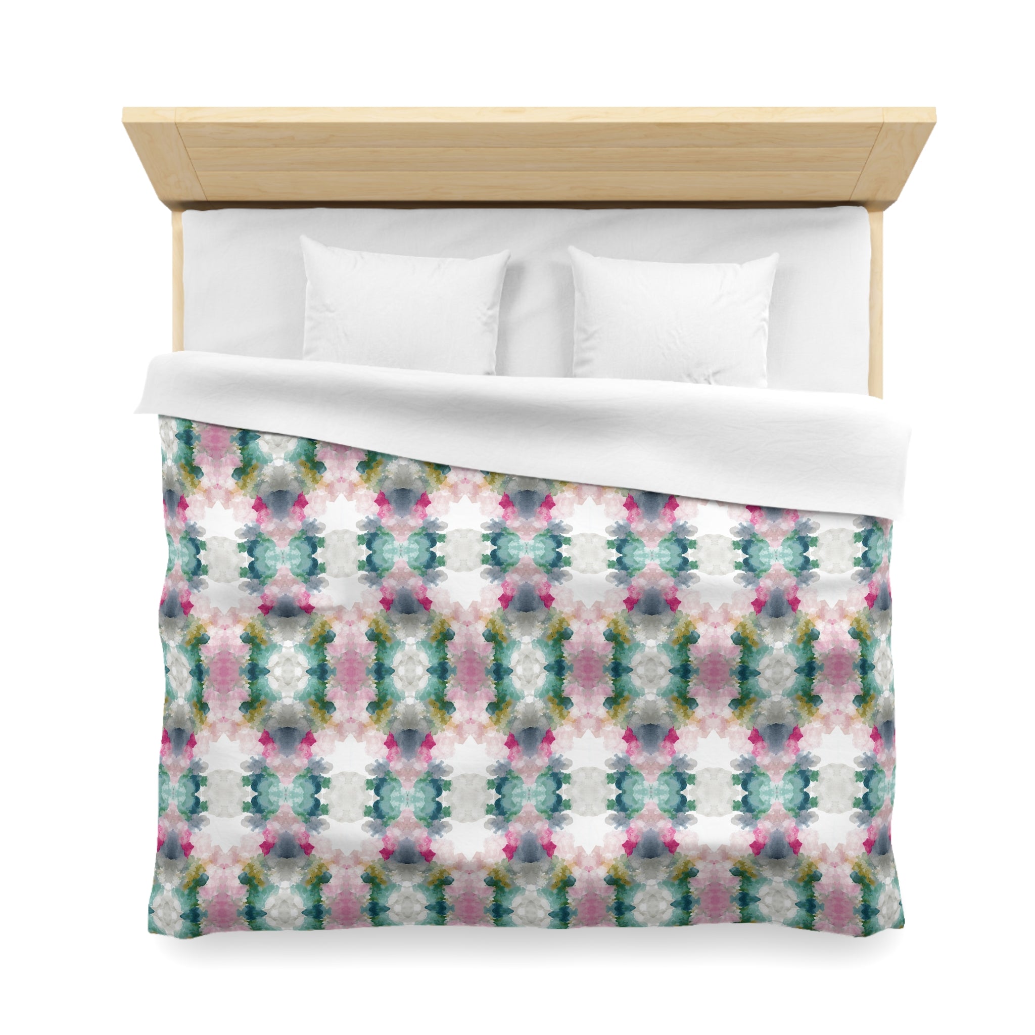a bed with a colorful, patterned comforter and pillows.