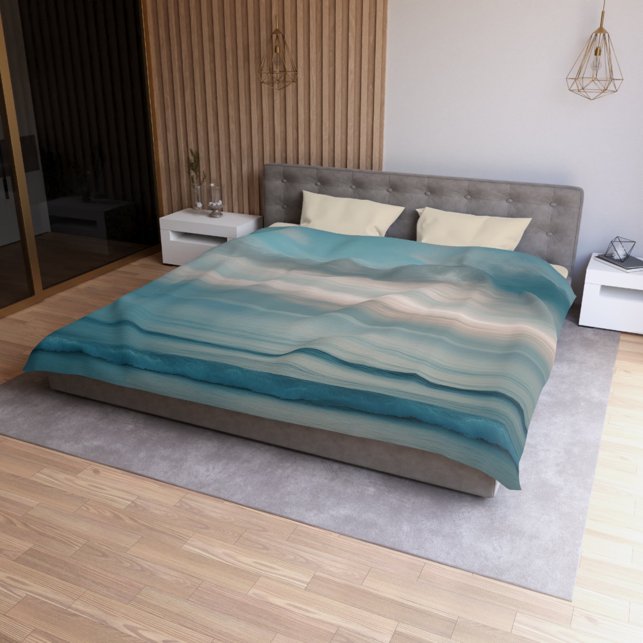 a modern bedroom with a large bed, a gray headboard, and a blue and white patterned comforter. The room has a wooden floor and white walls, creating a serene and stylish atmosphere.