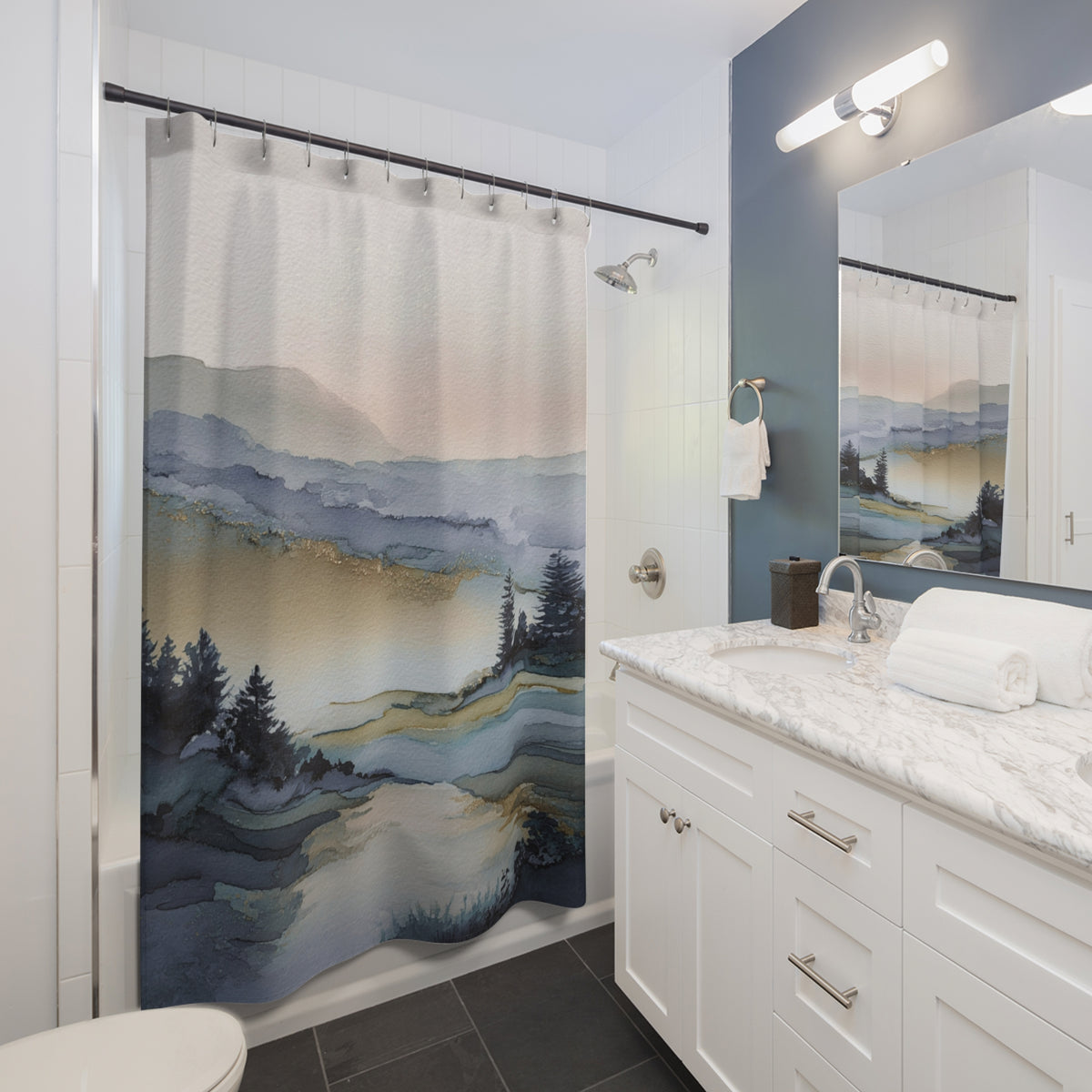 a bathroom with a shower curtain featuring a landscape scene, including mountains, trees, and a body of water. The bathroom has a white vanity and a mirror above it, and the overall color scheme is predominantly white and blue.