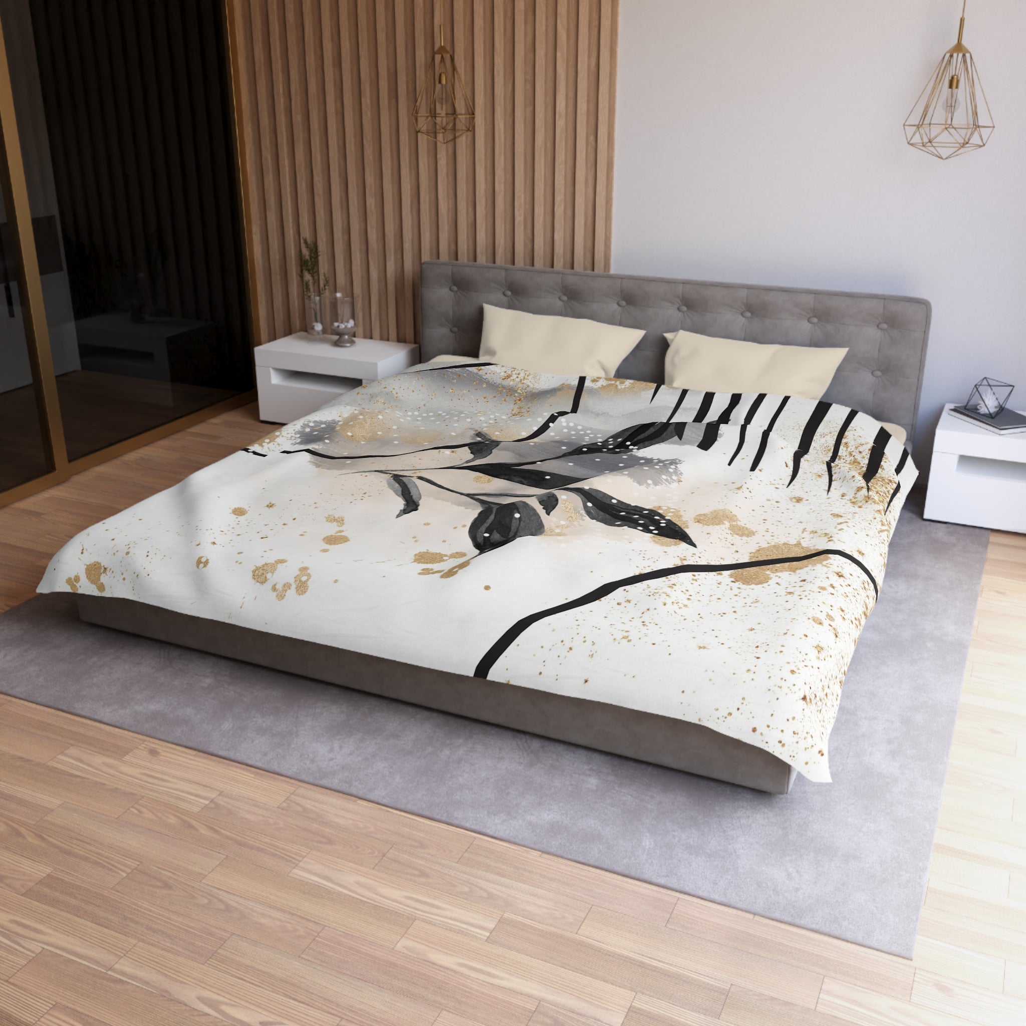 a modern bedroom with a large bed, a gray headboard, and a white nightstand on each side. The bed has a white and gold patterned comforter, and the room has a wooden floor and a gray area rug.
