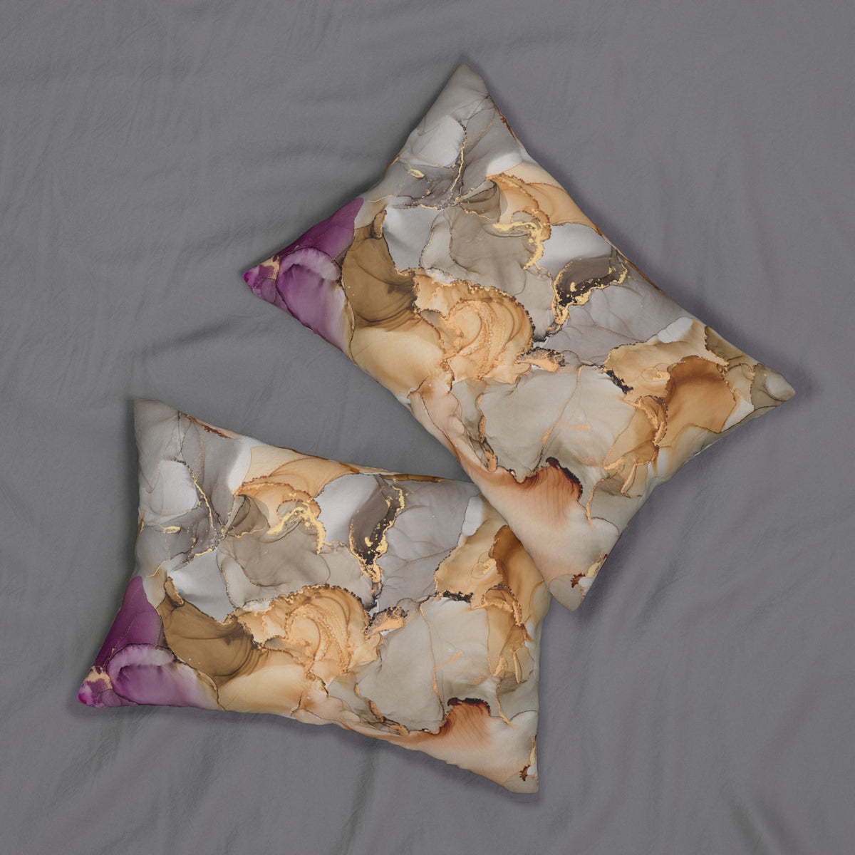 two decorative pillows with a marble-like pattern in shades of brown and beige, resting on a gray surface.
