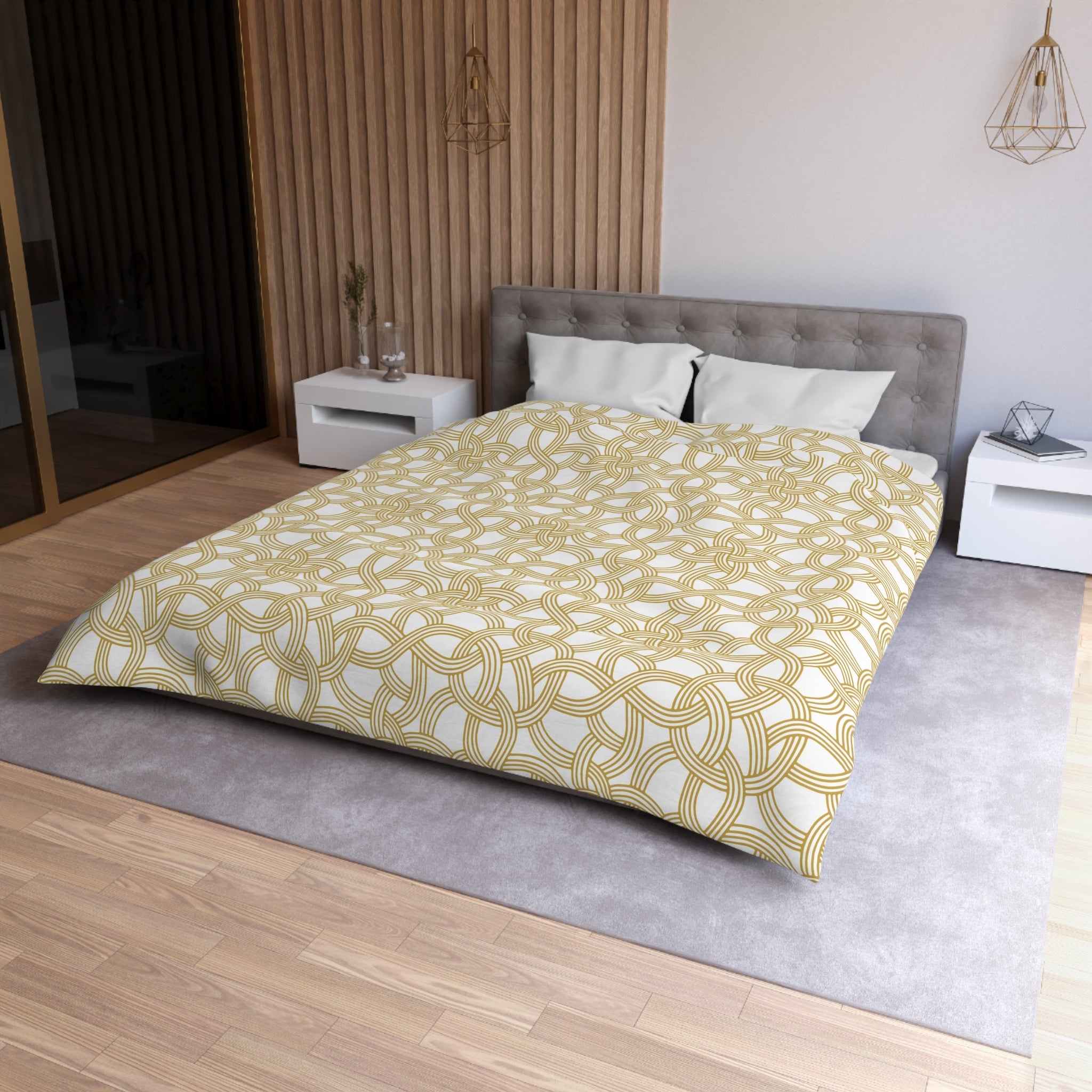 a modern bedroom with a large bed, a gray headboard, and a wooden wall. The bed is covered in a yellow and white patterned comforter, and there are two nightstands on either side of the bed. The room has a neutral color scheme with a gray carpet and a wooden floor.