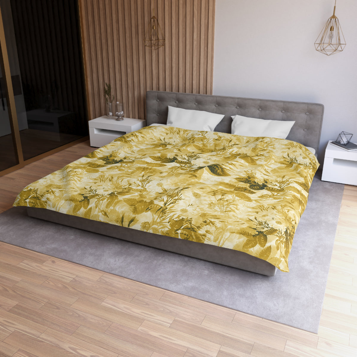 a modern bedroom with a large bed, a gray headboard, and a yellow and green floral comforter. The room has a wooden floor and white nightstands on either side of the bed.