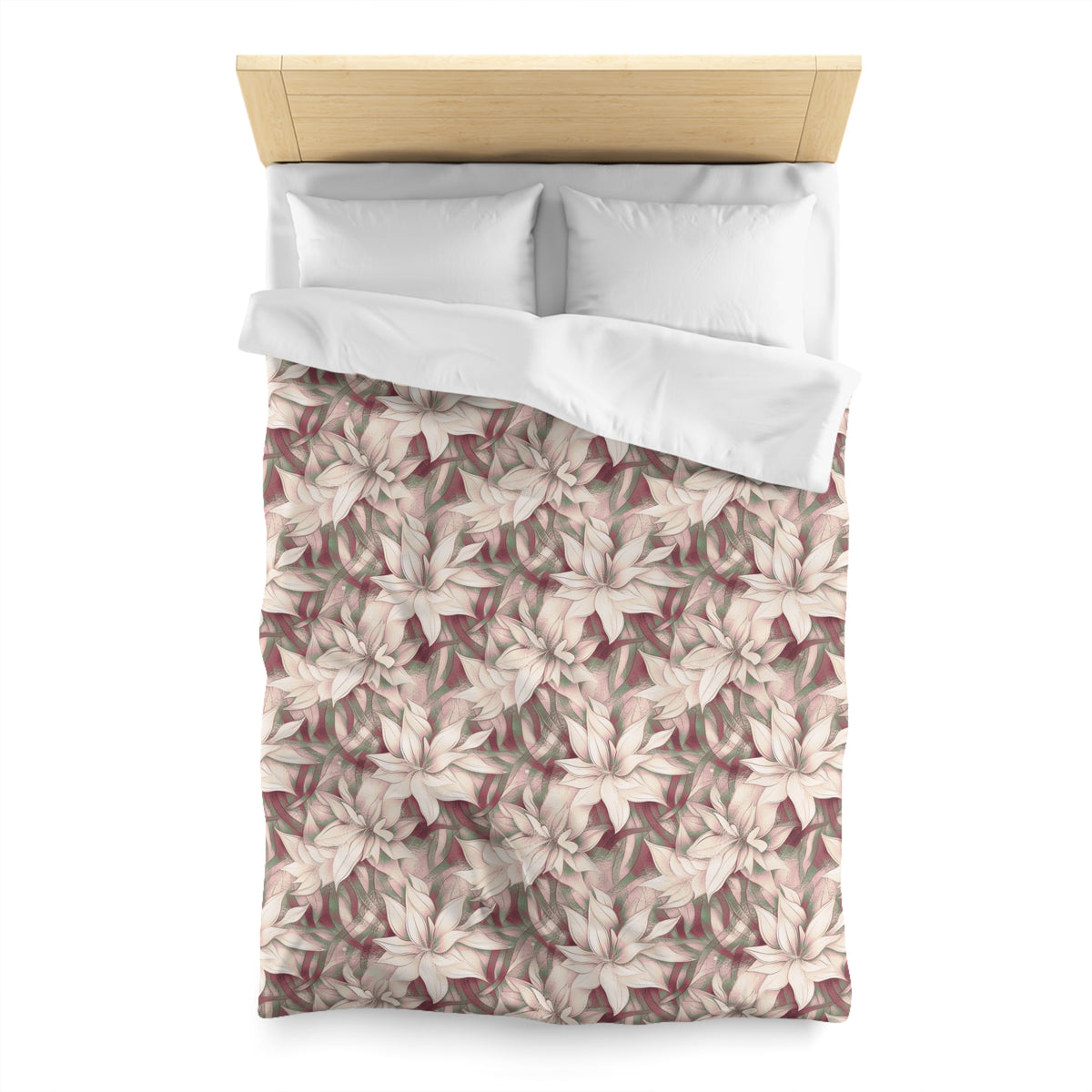 a bed with a floral patterned comforter and pillows.