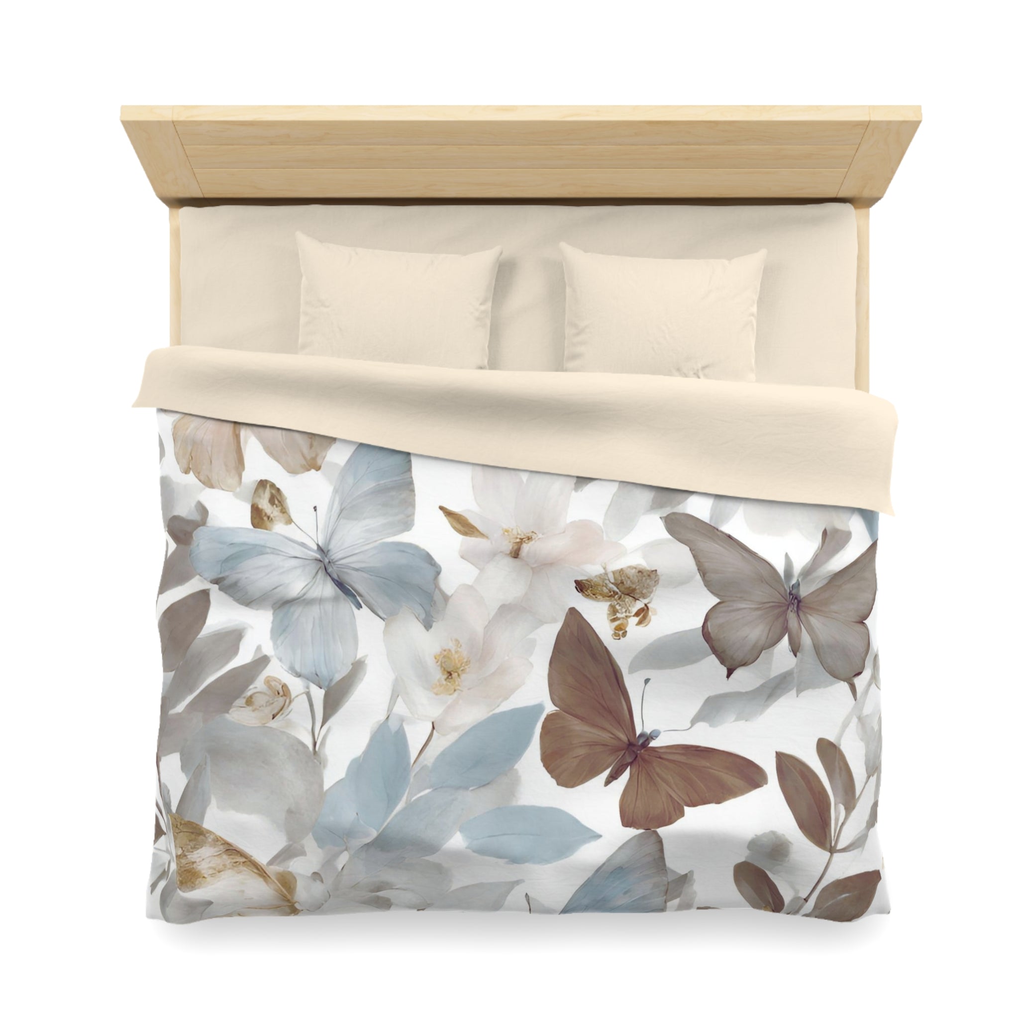 a bed with a floral print duvet cover featuring a design of butterflies and flowers in various shades of blue, white, and brown.