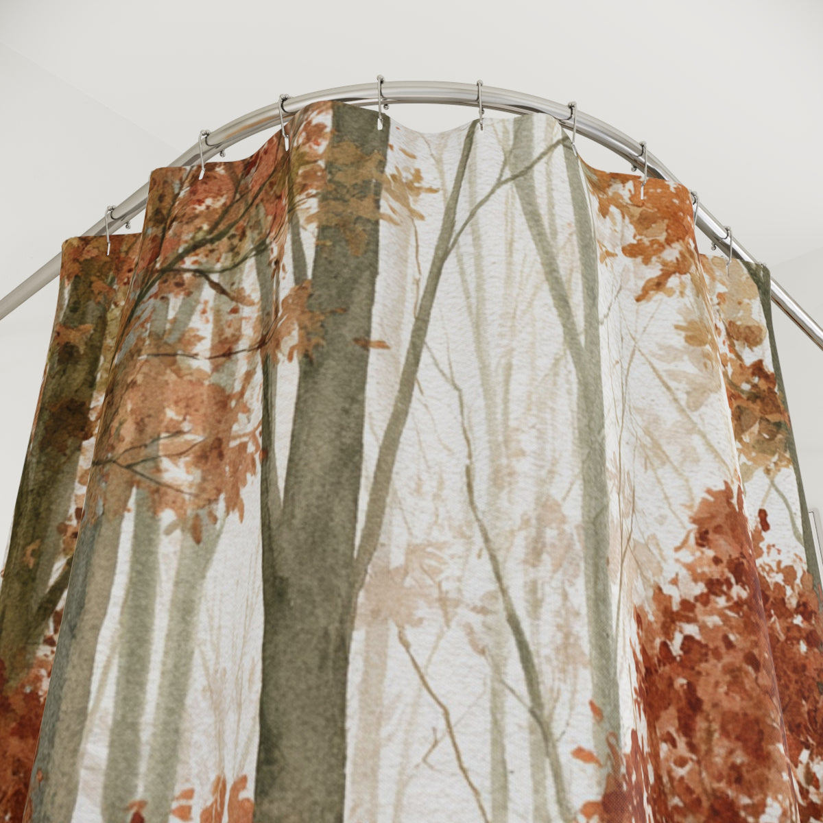 a shower curtain with a forest-themed design, featuring trees and foliage in shades of brown and green.