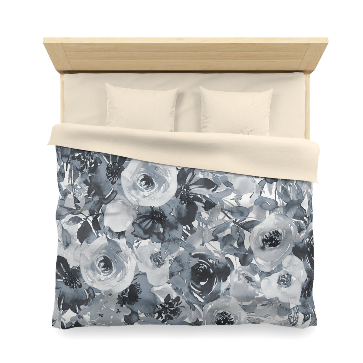 a bed with a floral patterned comforter and pillows.