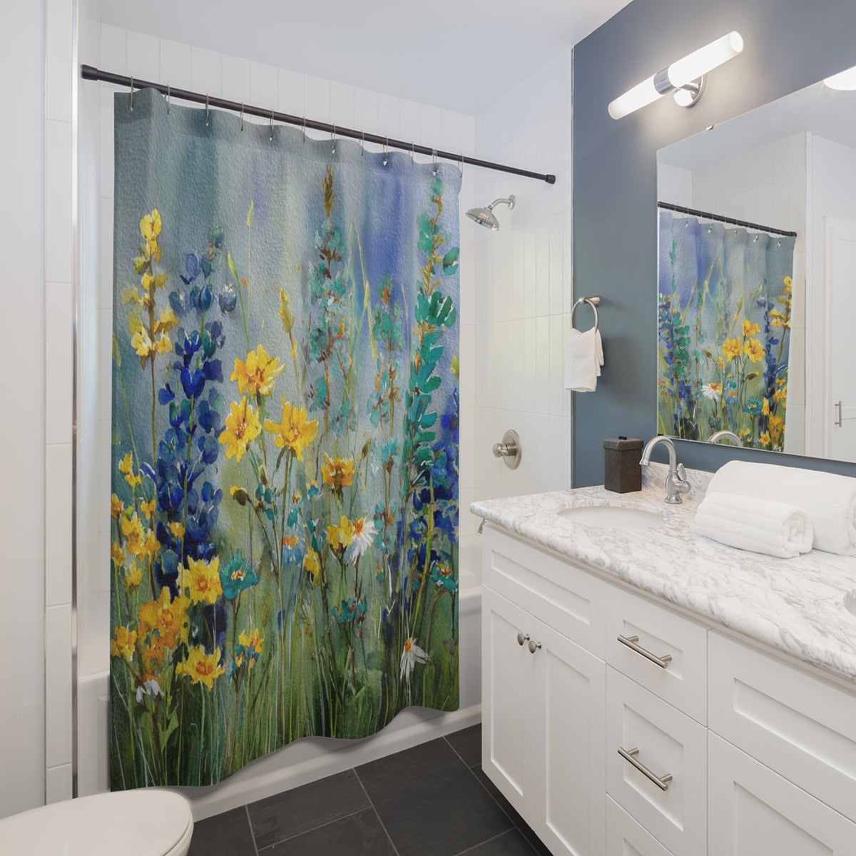 A bathroom with a shower curtain featuring a colorful floral design. The shower curtain is hanging in the shower area, and the bathroom has a white vanity and a mirror above it.