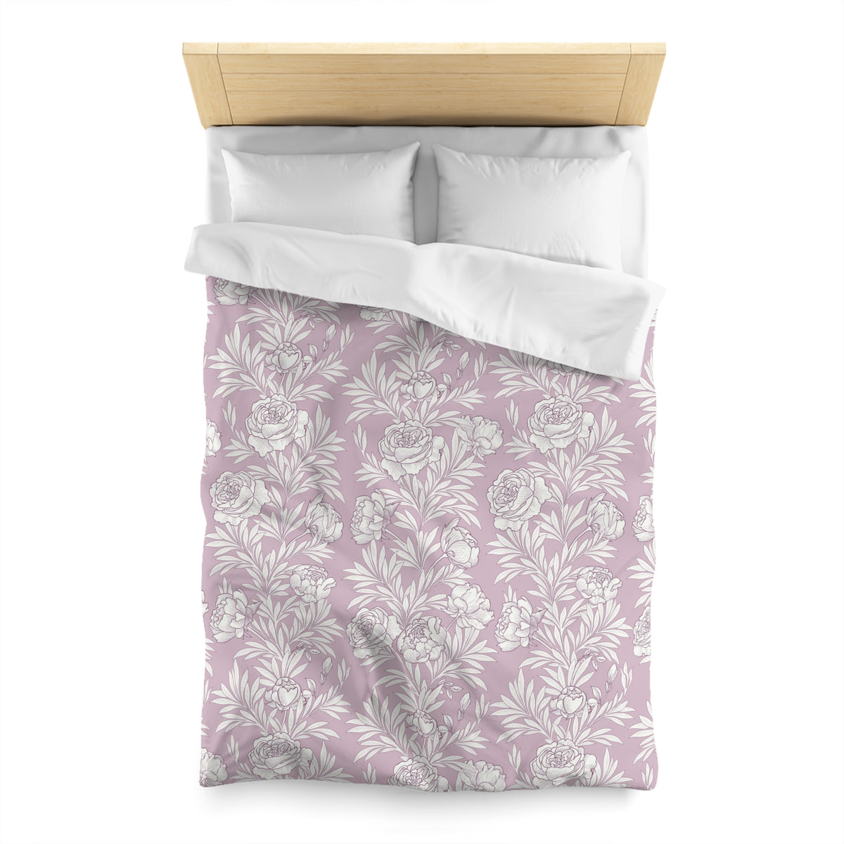 a neatly made bed with a floral patterned comforter and pillows.