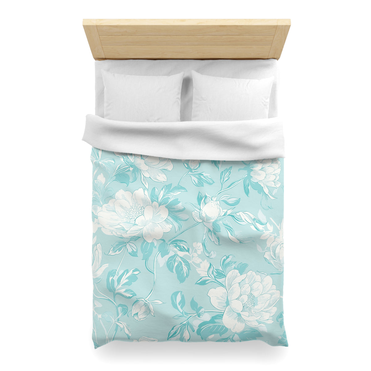 a neatly made bed with a floral patterned comforter and pillows.
