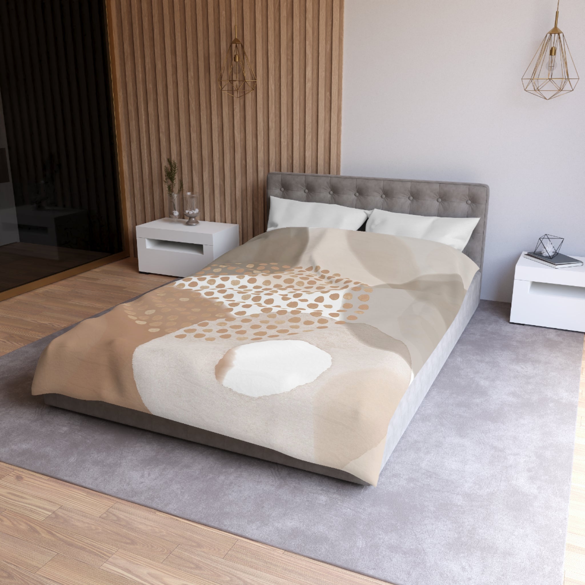 a modern bedroom with a gray tufted headboard, a gray bedspread with a pattern of brown and white polka dots, and white nightstands on either side of the bed.