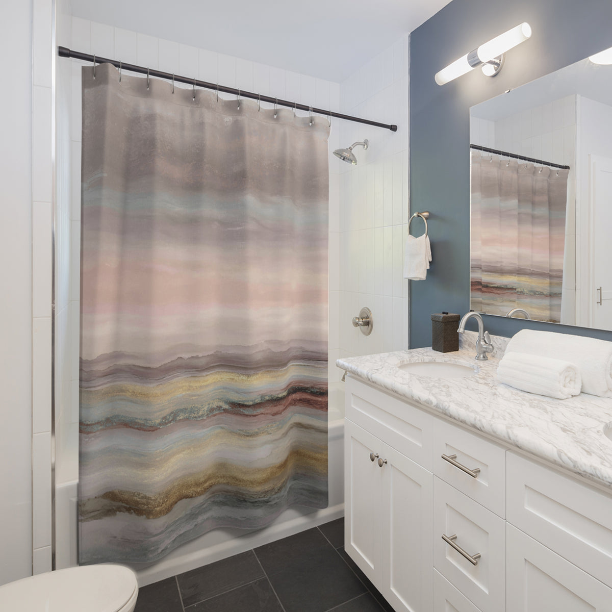 a modern bathroom with a white vanity, a shower curtain featuring a colorful abstract design, and a mirror above the vanity.