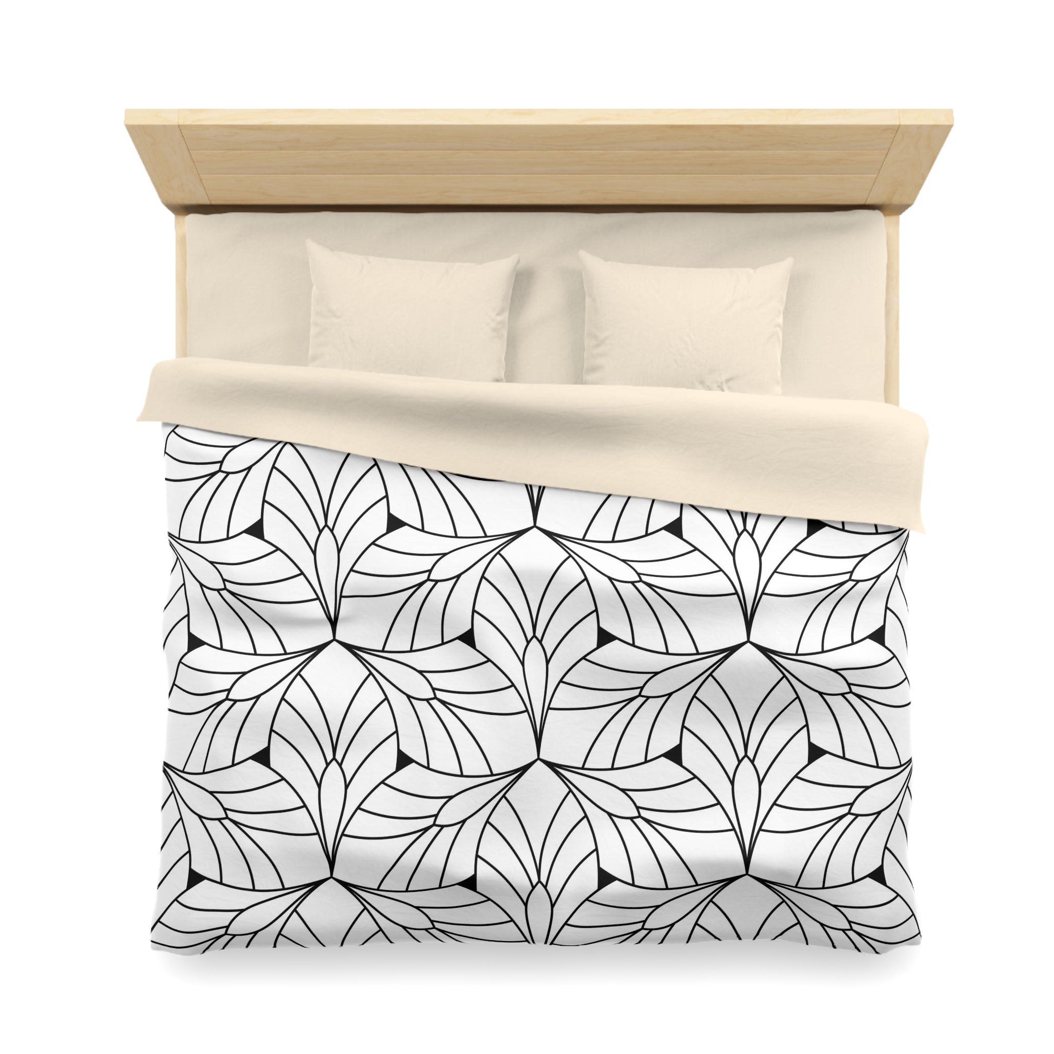 a neatly made bed with a black and white geometric patterned comforter and pillows.