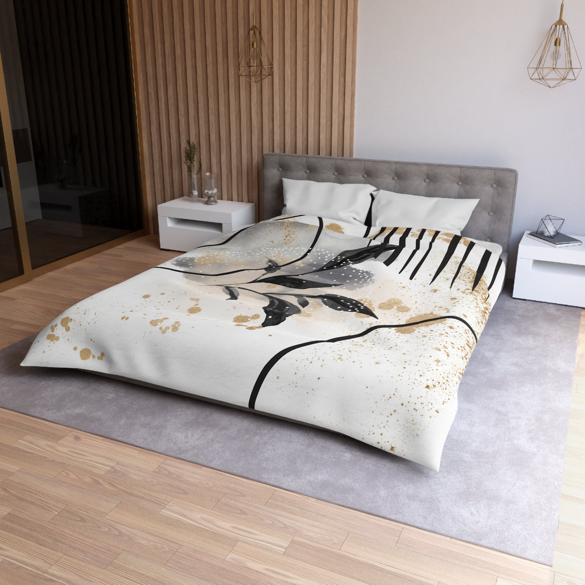 a modern bedroom with a large bed, a gray headboard, and a white nightstand on each side. The bed has a white and gold patterned comforter, and the room has a wooden floor and a gray area rug.