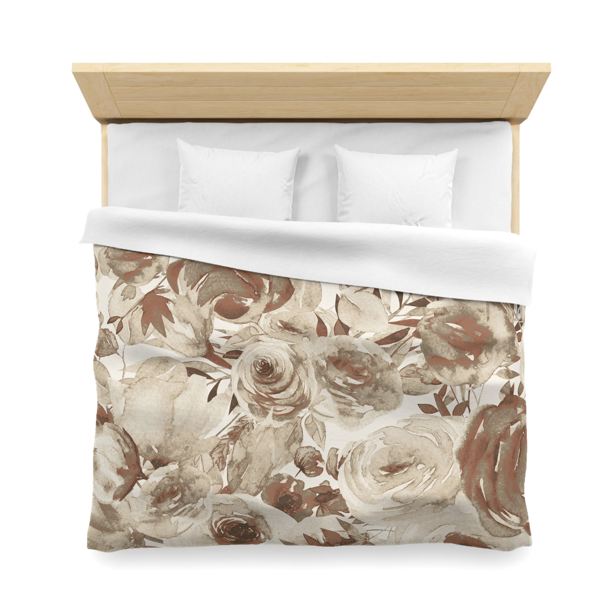 a neatly made bed with a floral print duvet cover and two white pillows.