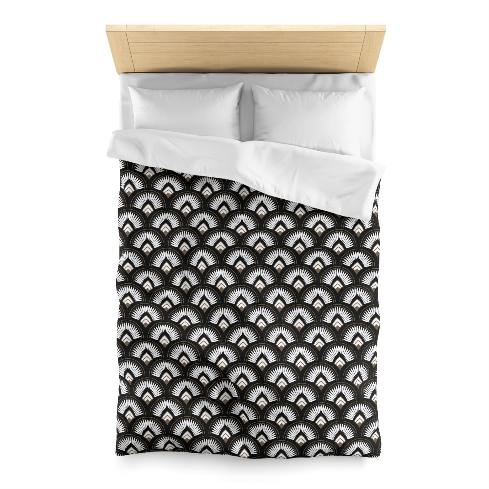 a neatly made bed with a black and white patterned comforter and pillows.