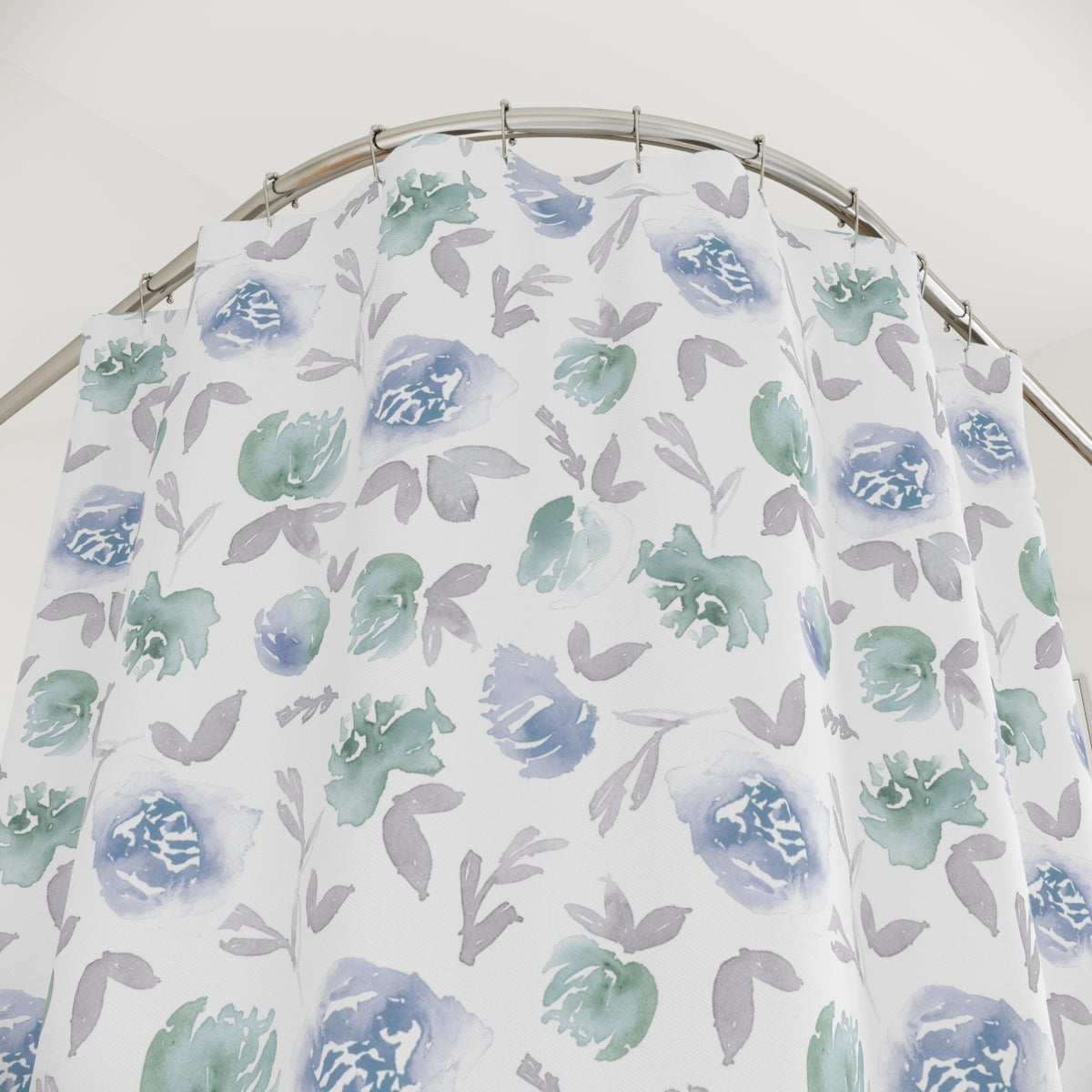 a shower curtain with a floral pattern in shades of blue and green.