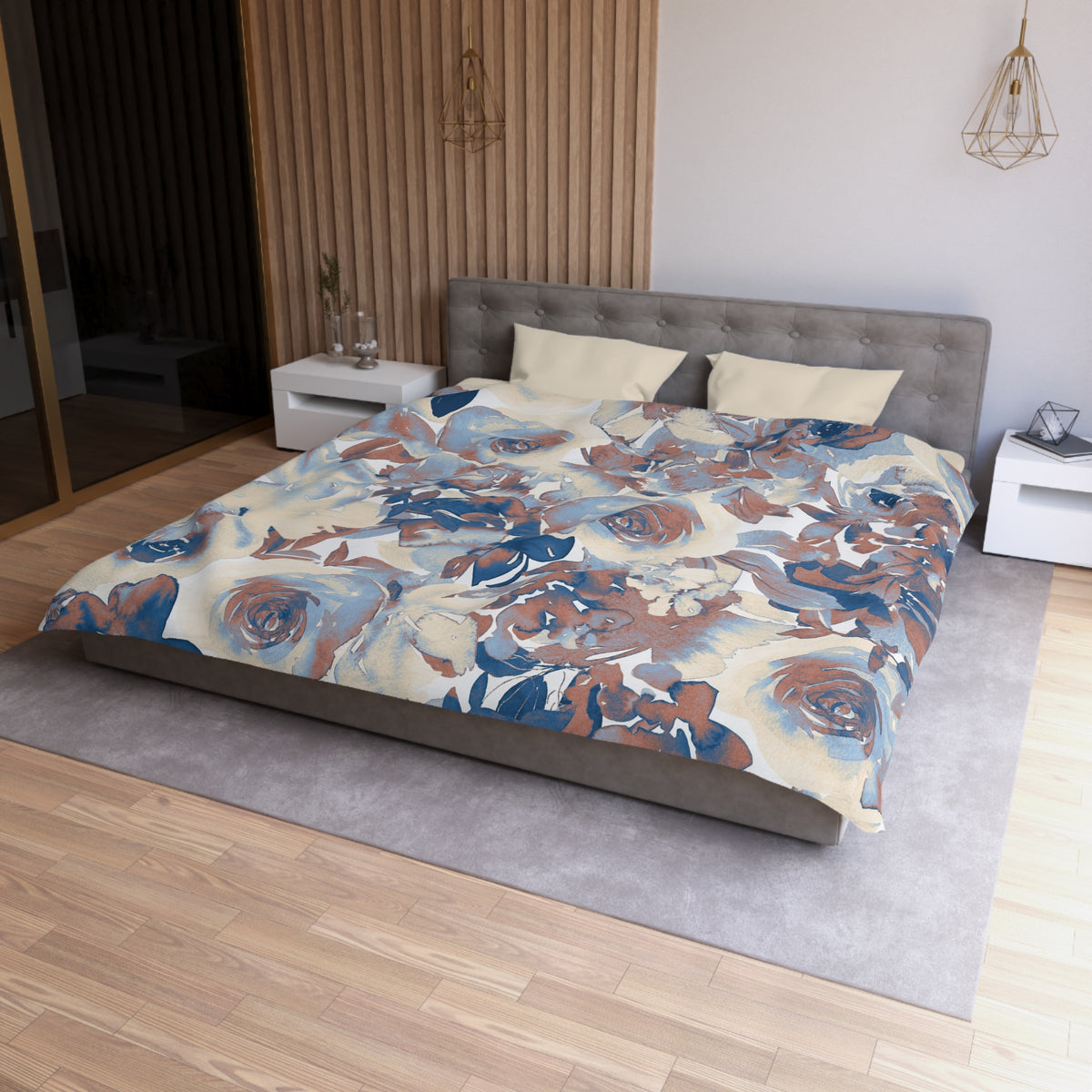 a modern bedroom with a large bed covered in a floral print comforter. The bed is positioned against a wall with a wooden panel. The room also features a nightstand, a pendant light, and a mirror.