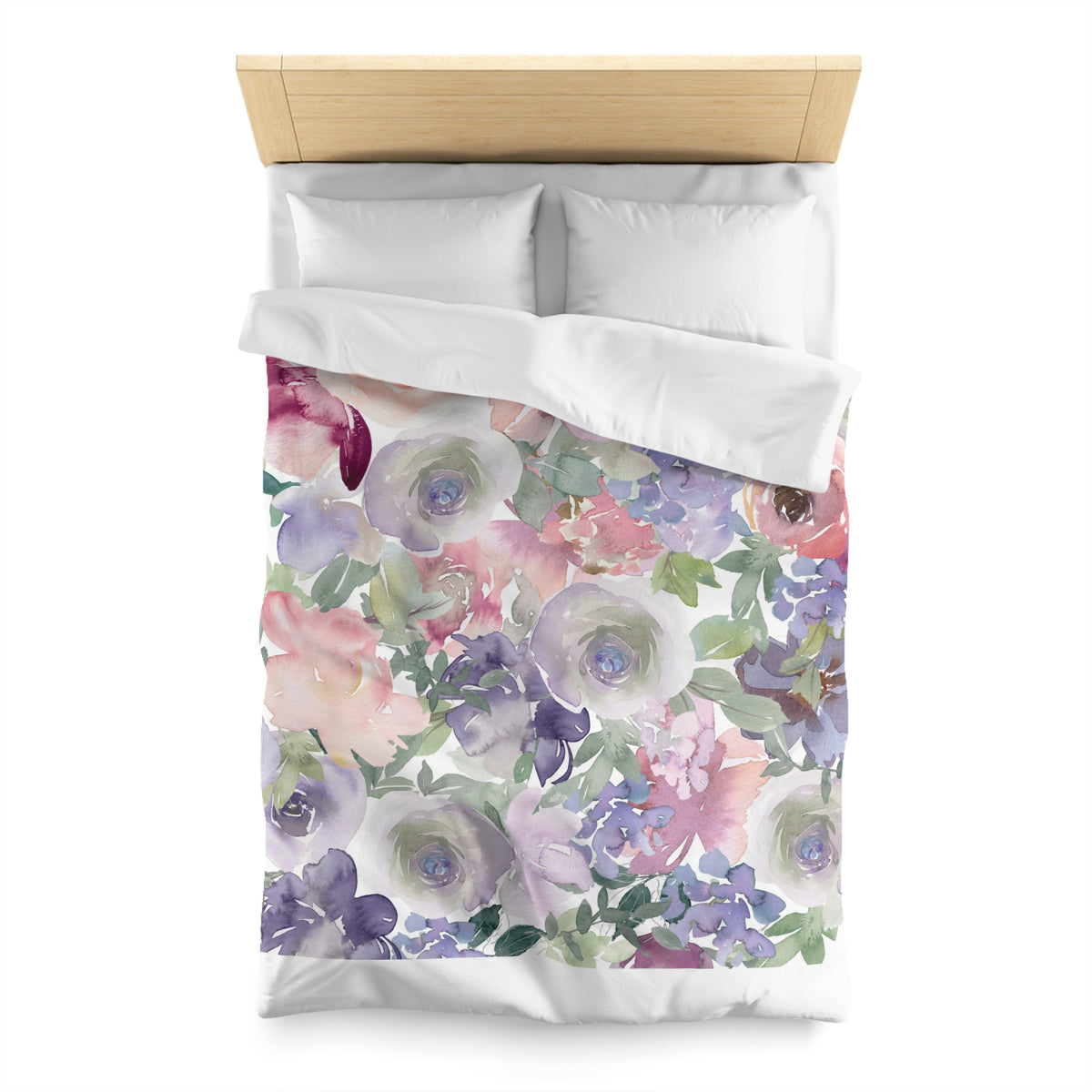 a bed with a floral print duvet cover and pillows.