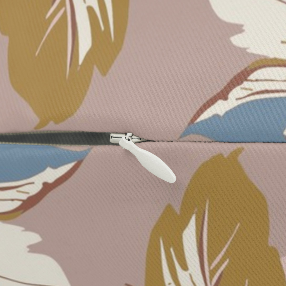 a close-up view of a zipper on a fabric, with a white zipper pull visible.