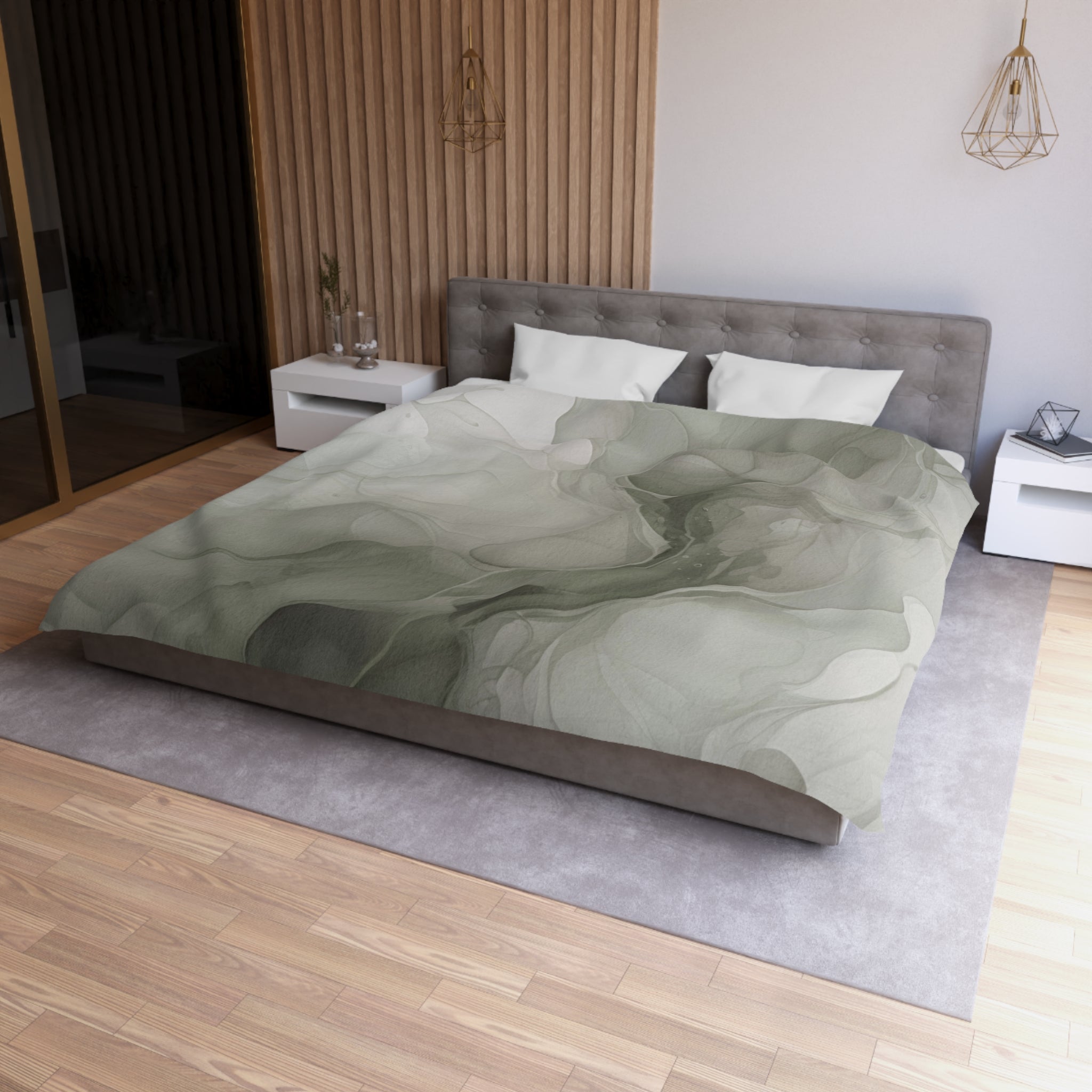a modern bedroom with a large bed, a gray headboard, and a gray and white patterned comforter. The room has a wooden floor and white walls, creating a serene and minimalist atmosphere.