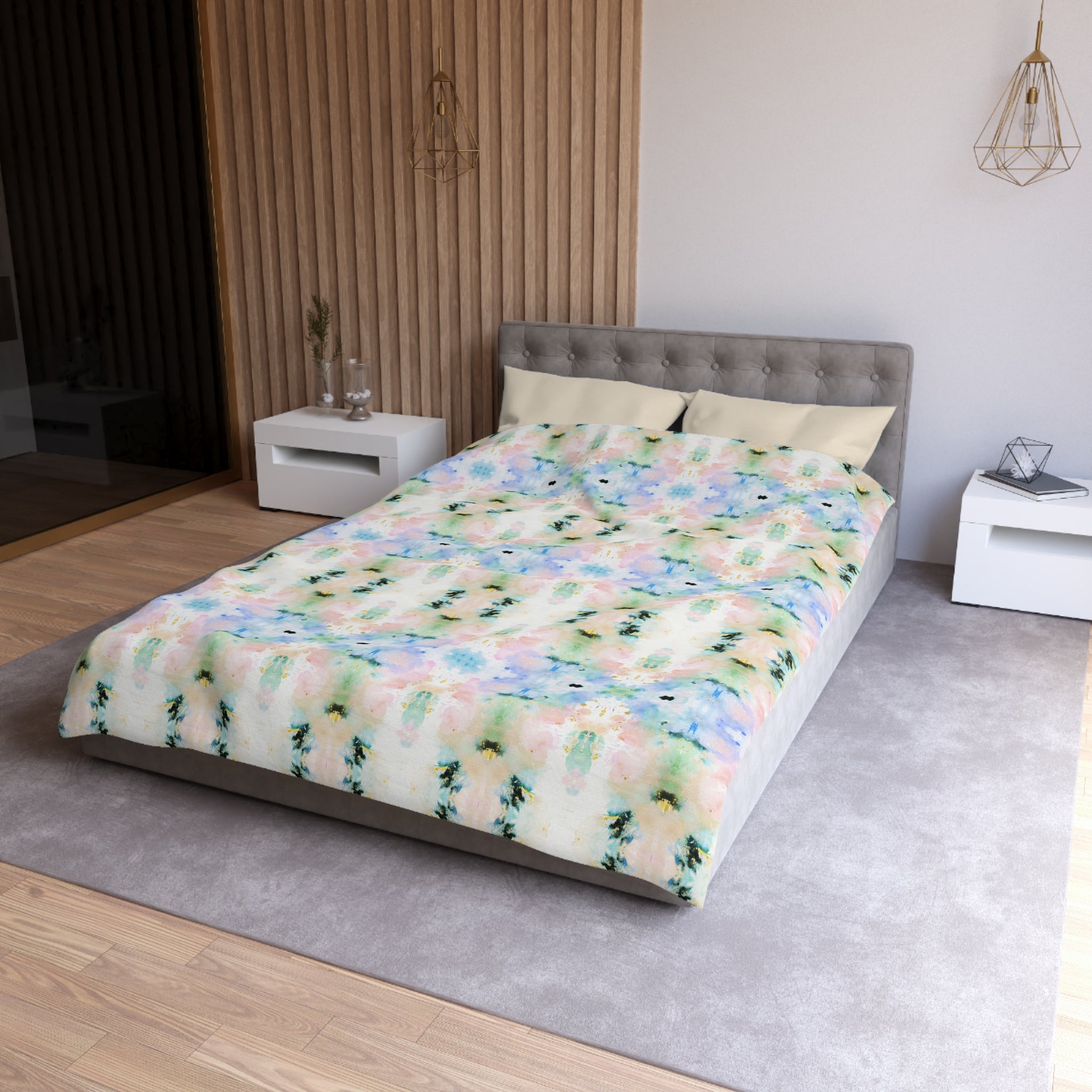 a modern bedroom with a gray tufted headboard, a colorful patterned comforter, and a white nightstand on the left side.