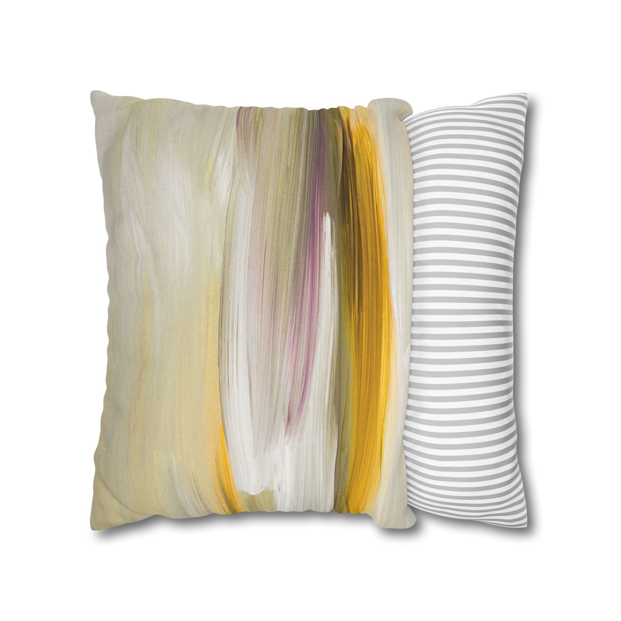 a square throw pillow with a vibrant abstract design in shades of yellow, white, and pink.