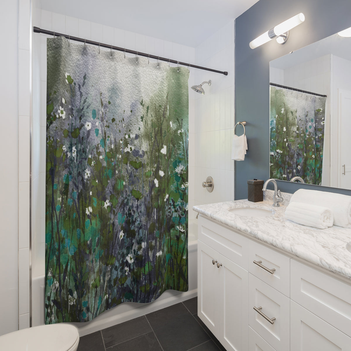 a modern bathroom with a white vanity, a shower curtain featuring a floral pattern, and a mirror above the vanity.