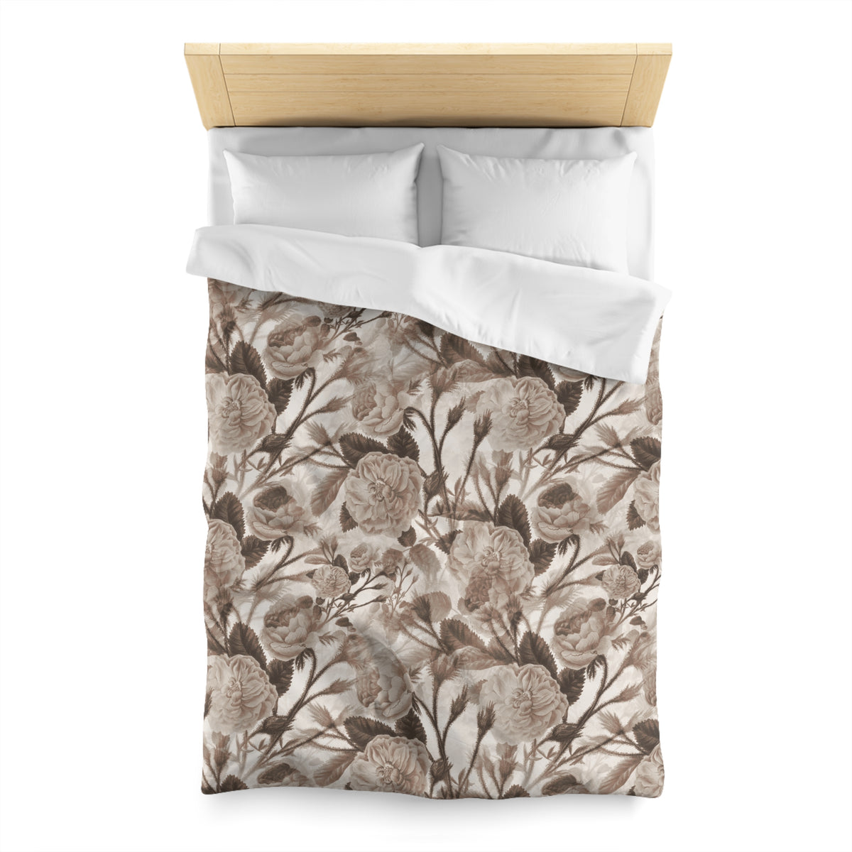 a neatly made bed with a floral patterned comforter and pillows.