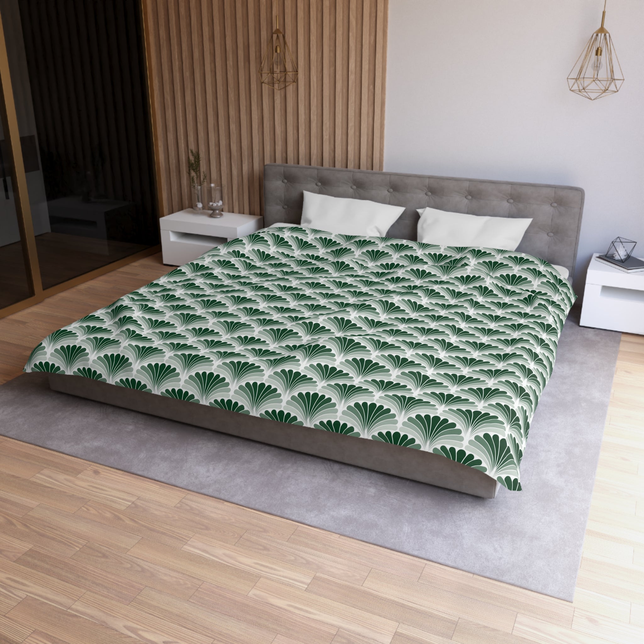 a modern bedroom with a large bed, a gray headboard, and a green and white patterned comforter. The room has a wooden floor and white walls, creating a clean and minimalist aesthetic.