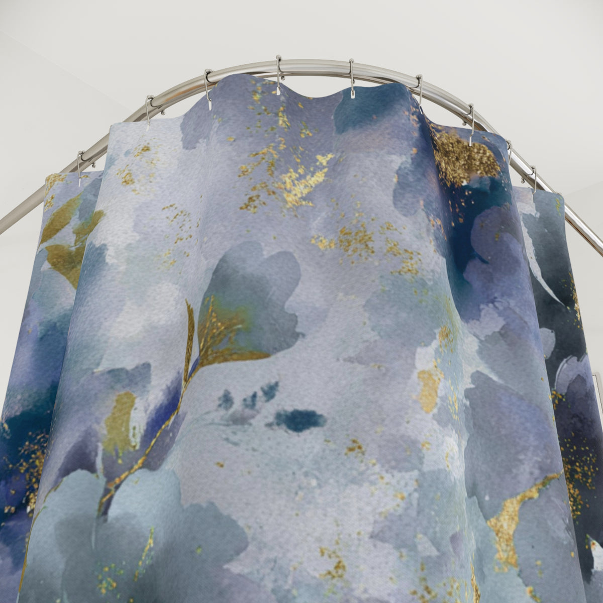 a shower curtain with a blue and gold floral pattern.