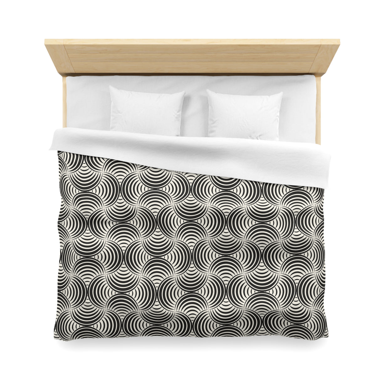 a neatly made bed with a black and white patterned comforter and two white pillows.