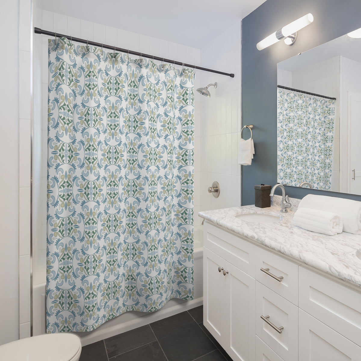 a modern bathroom with a white vanity, a shower curtain with a patterned design, and a mirror above the vanity.