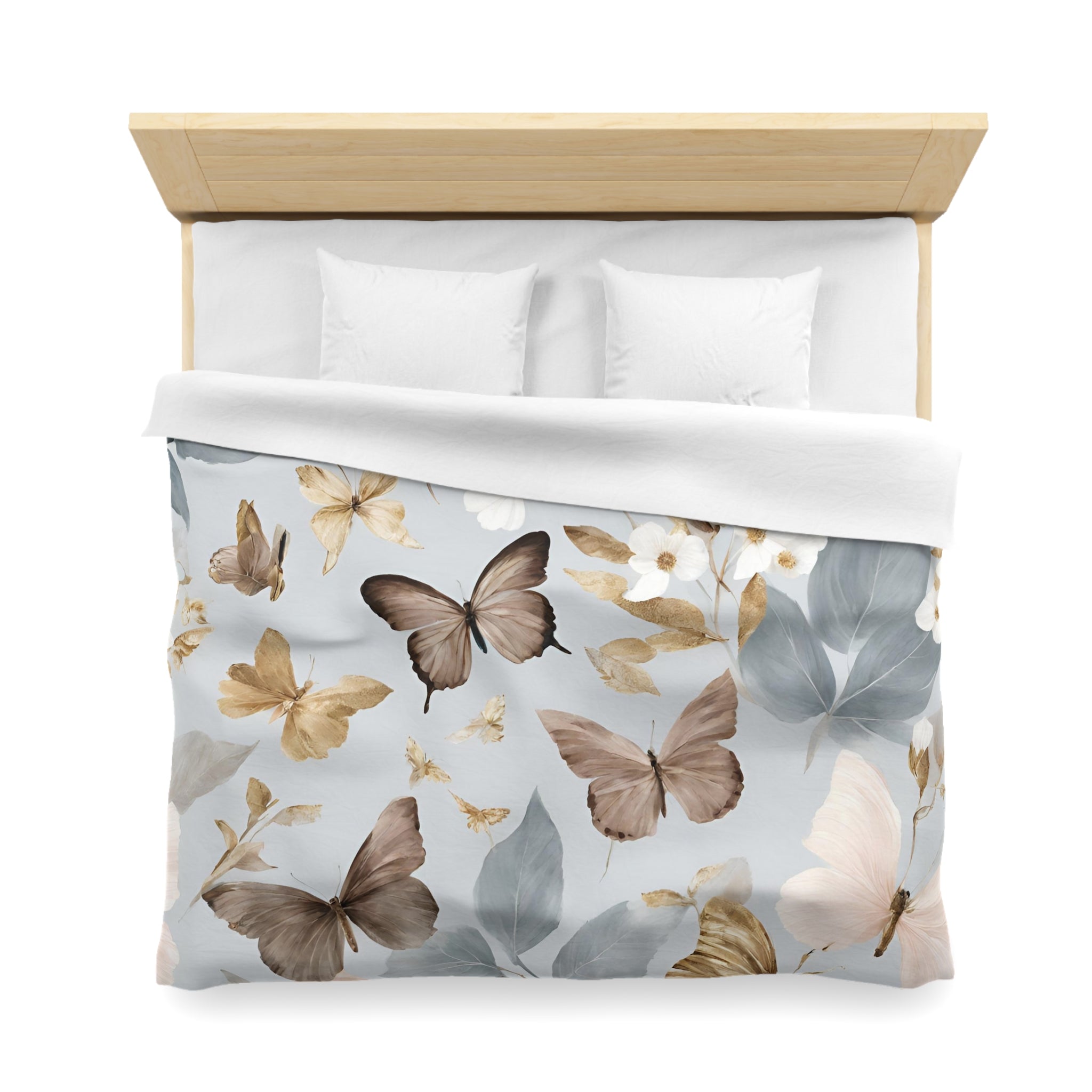 a bed with a white comforter and pillows, featuring a pattern of brown and white butterflies on the comforter.