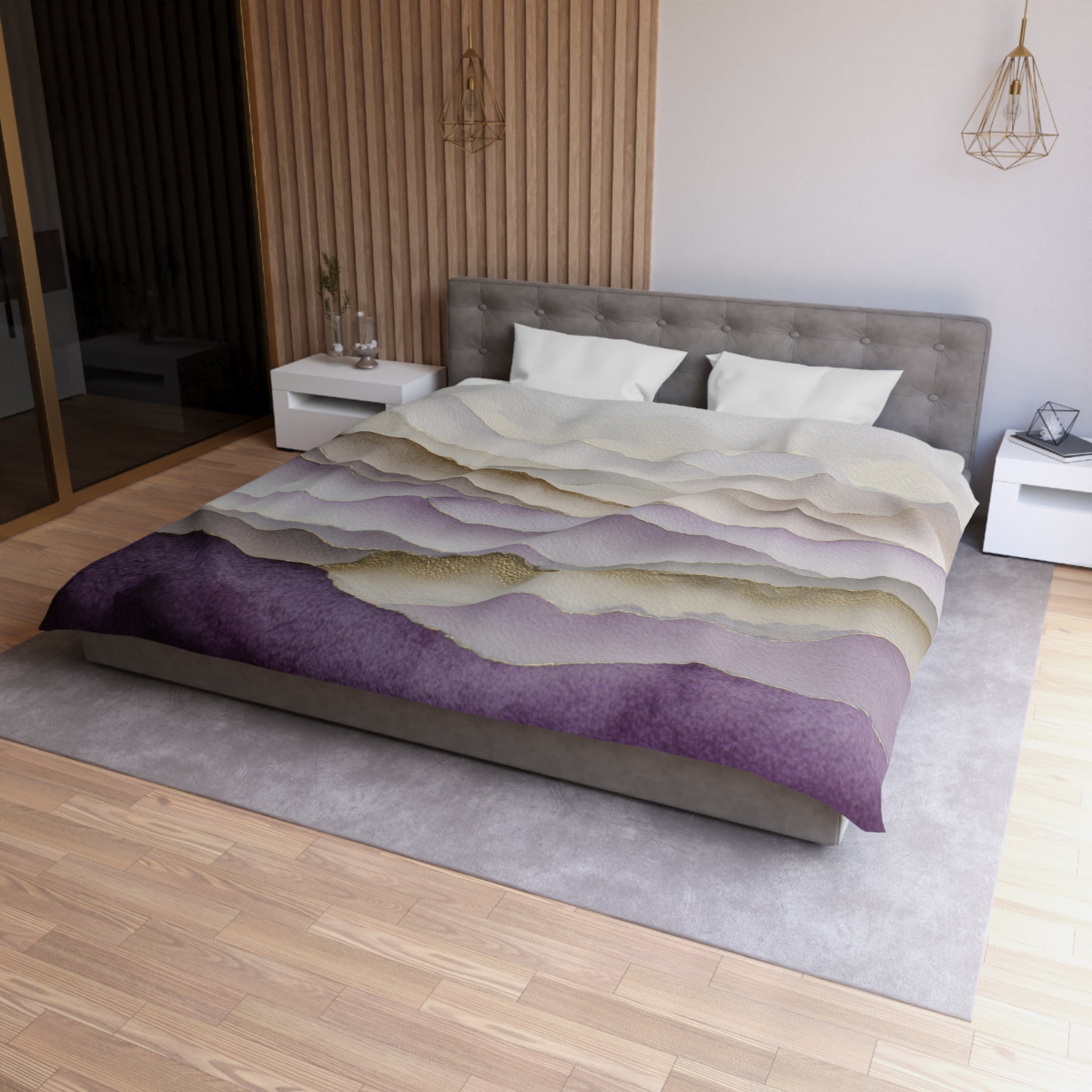a modern bedroom with a large bed, a gray headboard, and a purple and white patterned comforter. The room has a wooden floor and white walls, creating a clean and minimalist aesthetic.