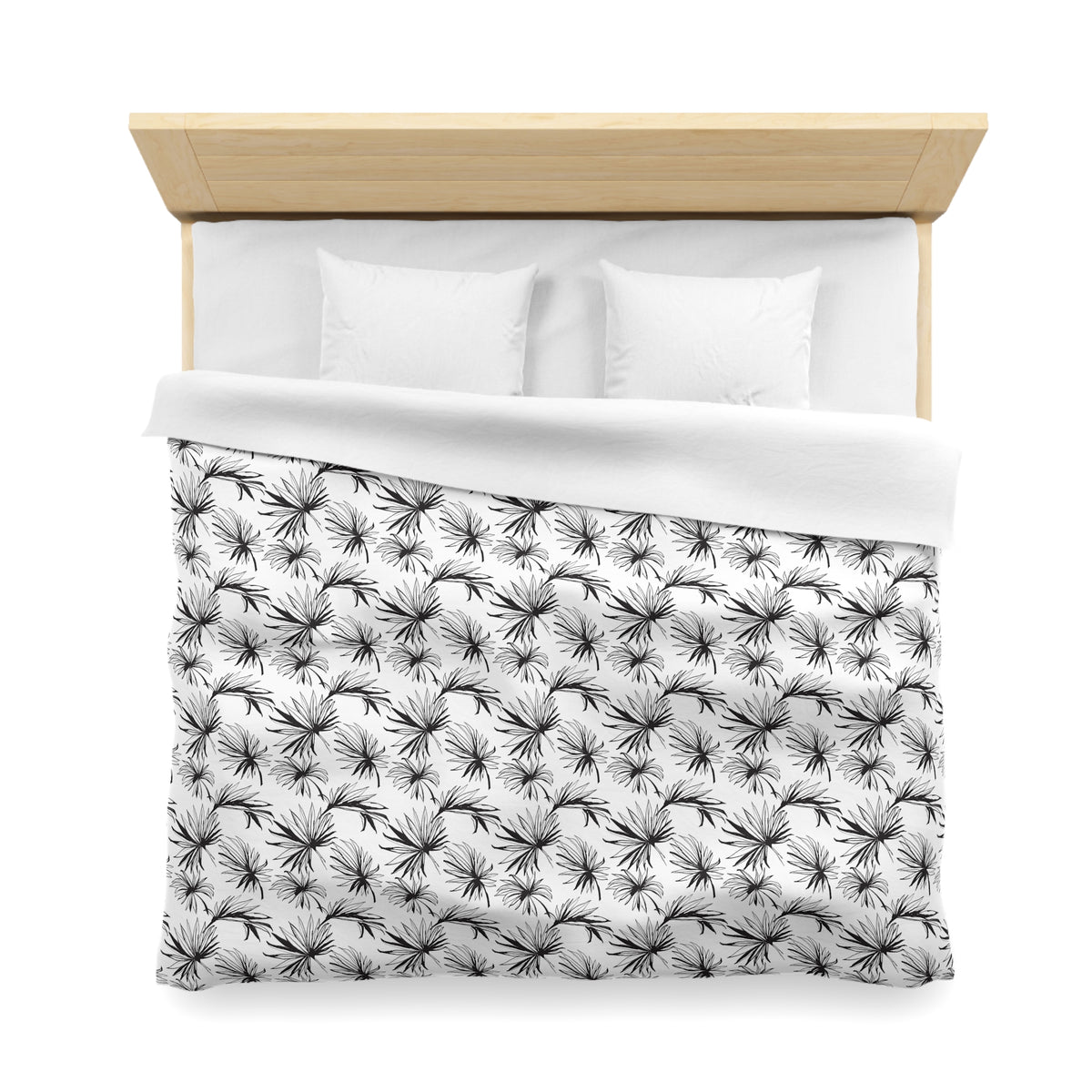 a neatly made bed with a white comforter and a patterned black and white blanket.
