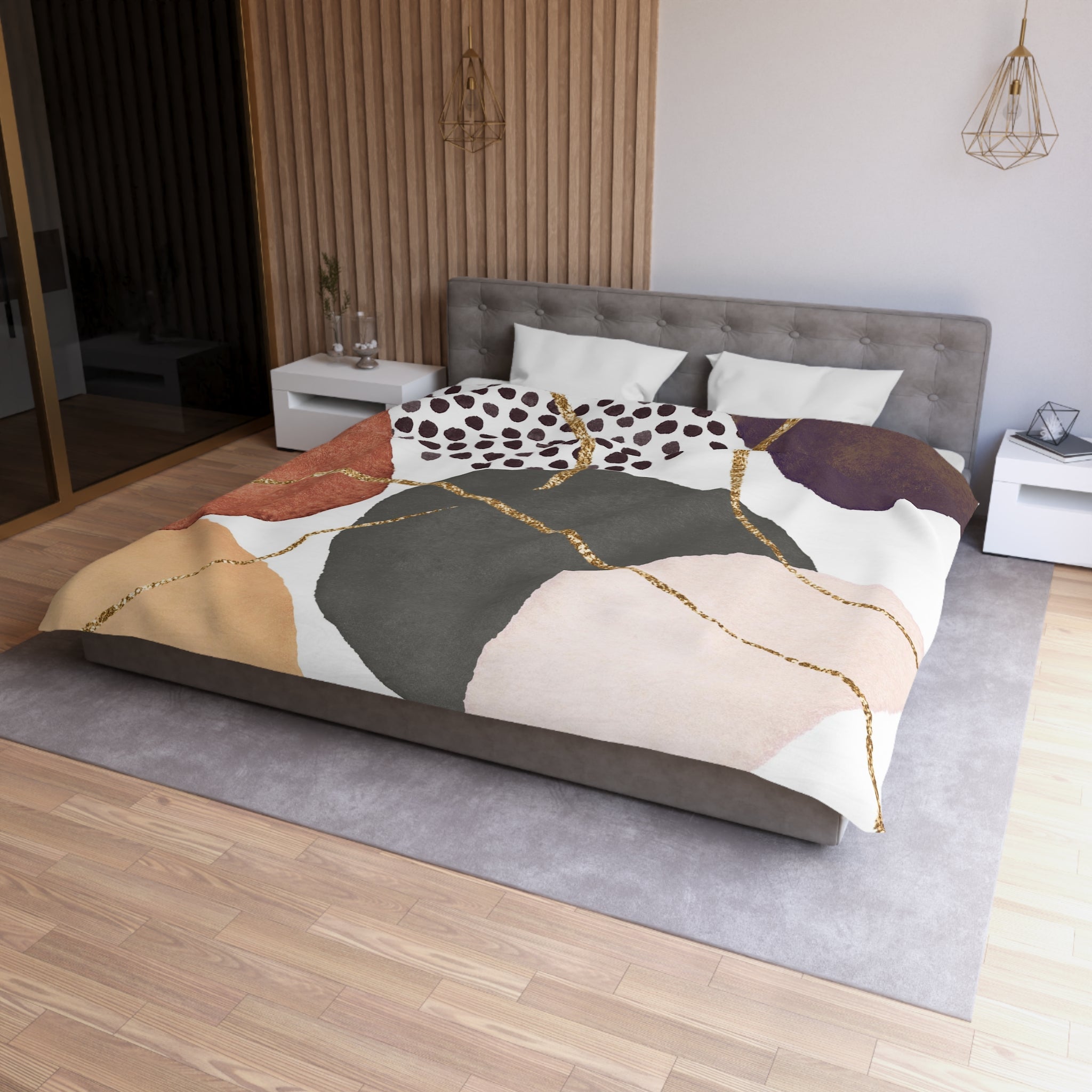 a modern bedroom with a large bed featuring a colorful abstract patterned comforter. The bed is positioned against a wall with a wooden panel, and there are two nightstands on either side of the bed. The room has a minimalist and contemporary design, with a gray color scheme and a wooden floor.