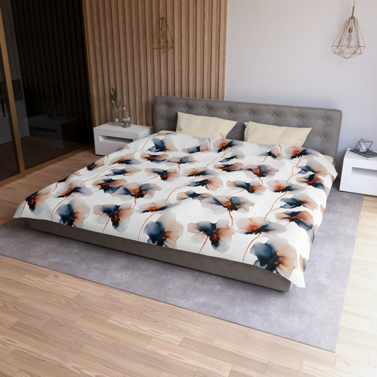 a modern bedroom with a large bed featuring a floral print comforter and pillows. The bed is positioned against a wall with a wooden panel, and there are two nightstands on either side of the bed. The room has a wooden floor and a gray area rug, creating a cozy and inviting atmosphere.