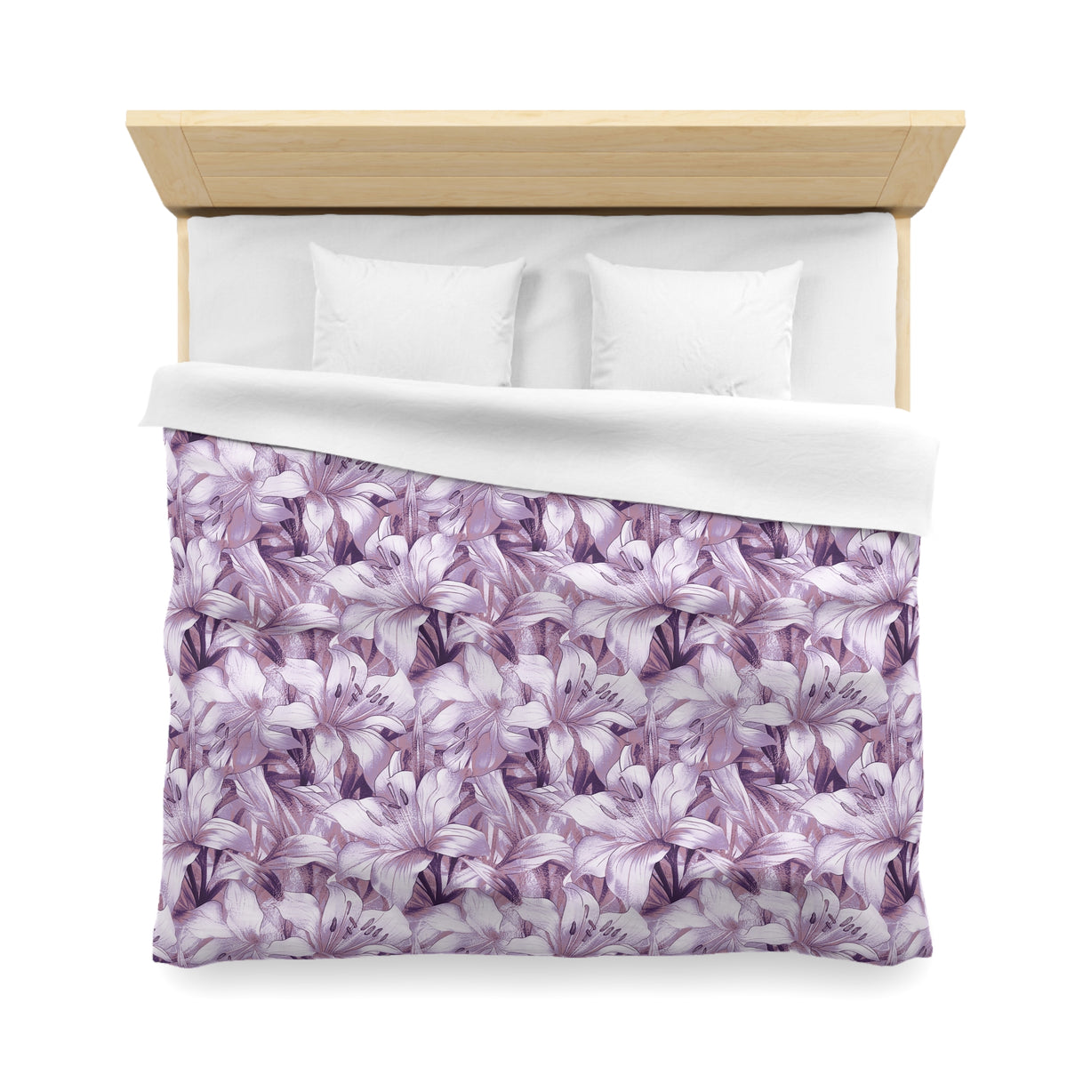 a bed with a purple floral patterned comforter and pillows.