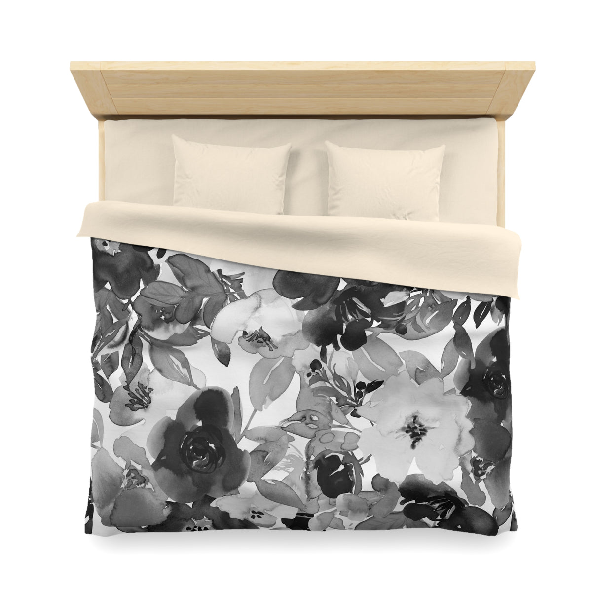 a neatly made bed with a floral print duvet cover and two pillows.